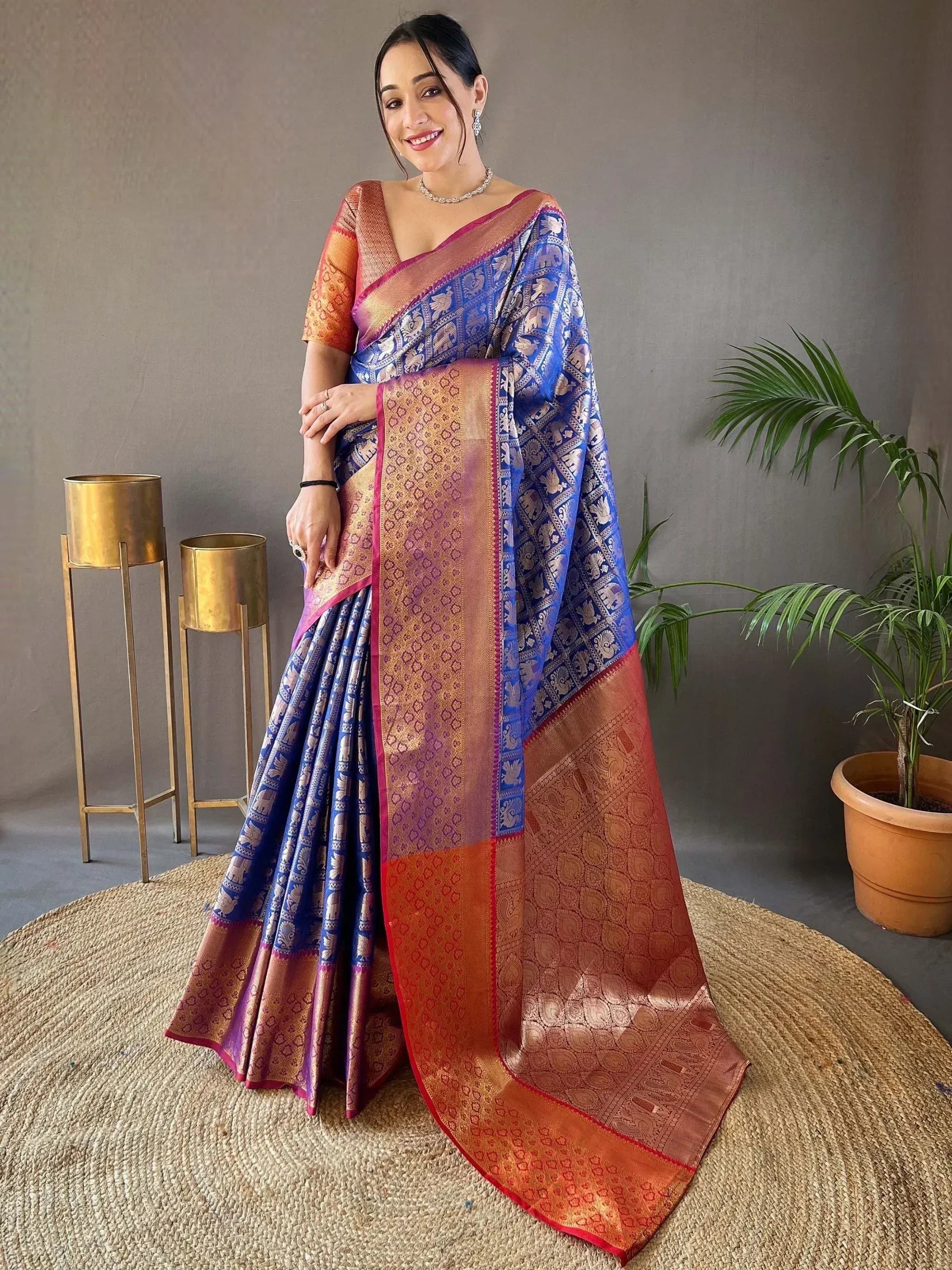 Blue and gold designer saree with intricate elephant motifs and rich border details