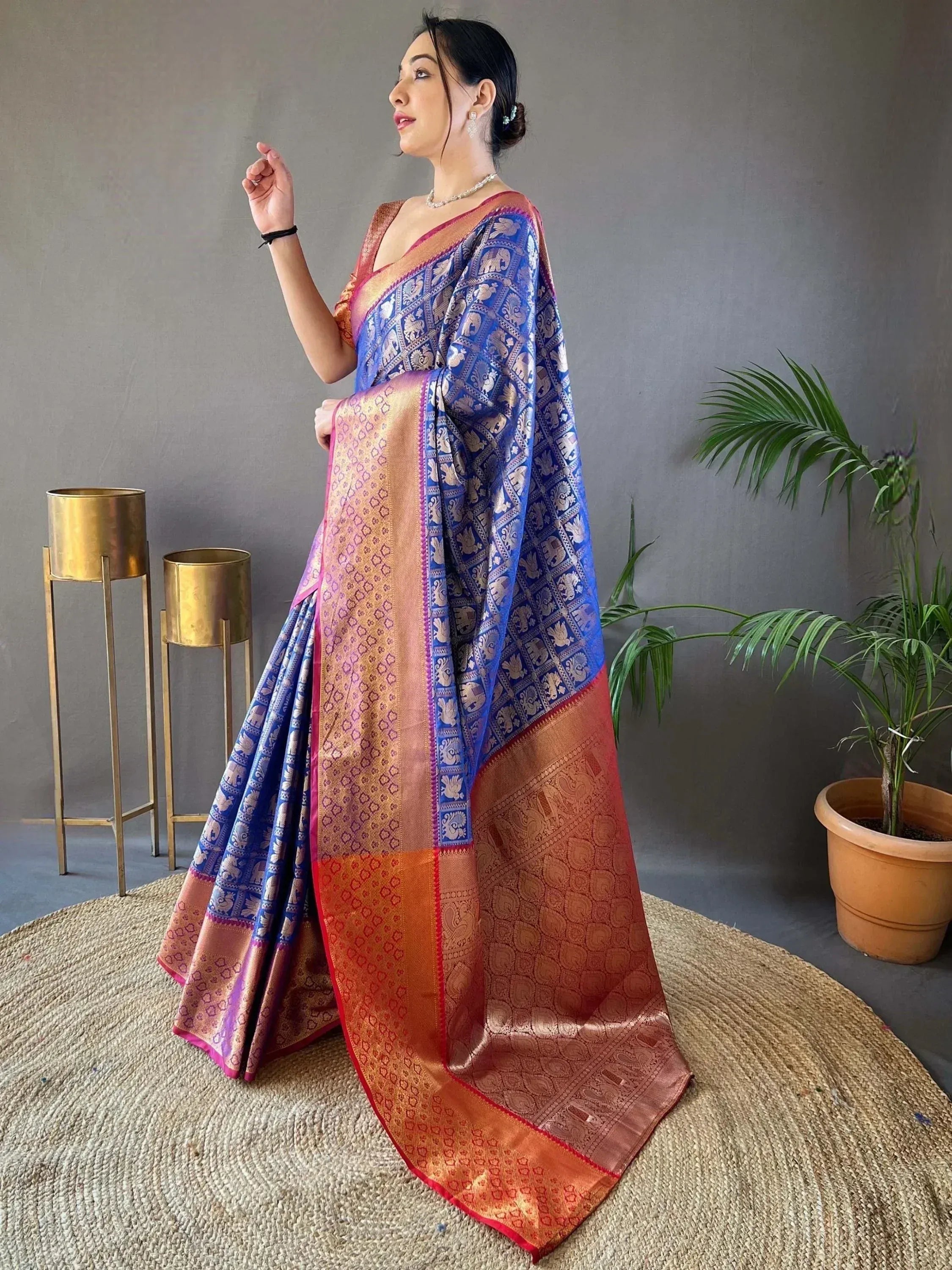 Elegant blue and gold designer saree with intricate elephant motifs, perfect for ethnic wear.