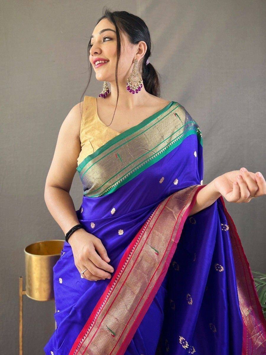 Woman in royal blue silk saree with gold and green border, paired with golden blouse, perfect for Indian ethnic occasions.