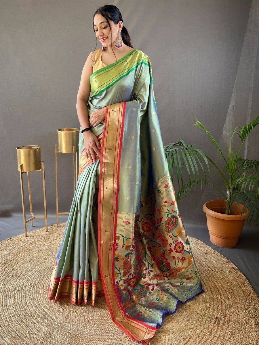 Woman in elegant light green silk saree with floral border, perfect for Indian ethnic occasions