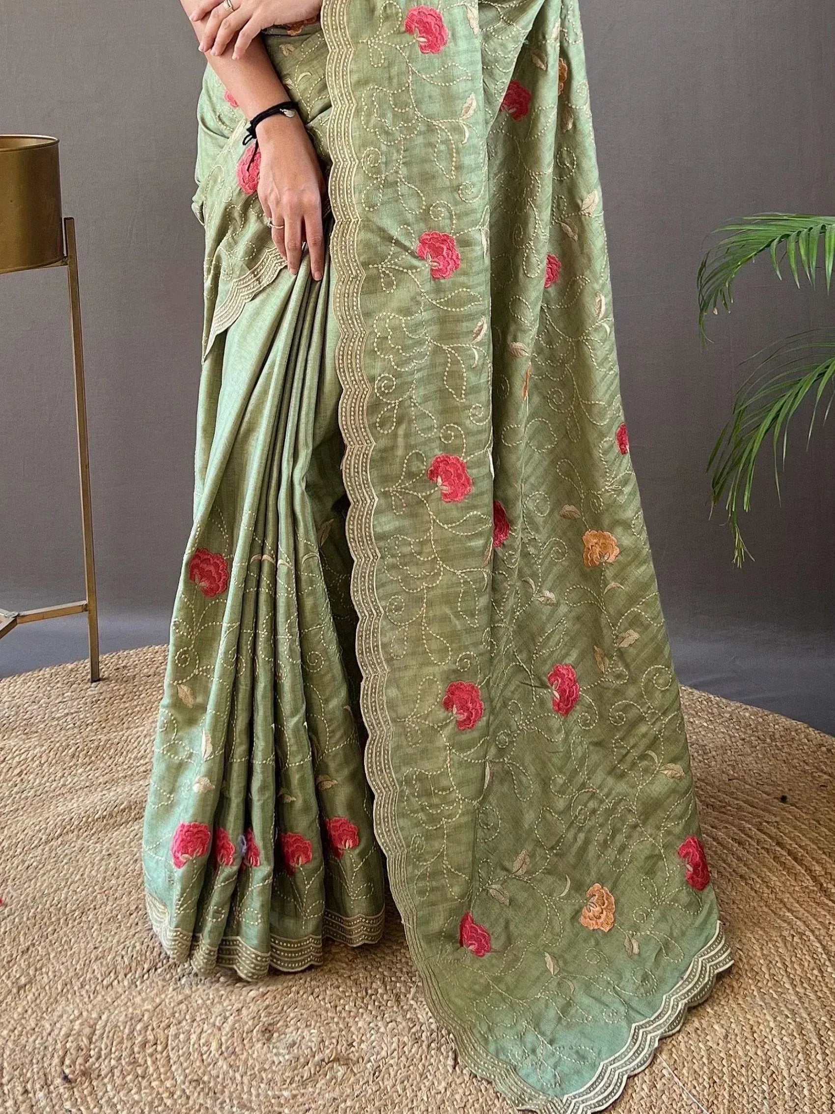 Green embroidered saree with pink floral motifs and scalloped border, Indian ethnic wear