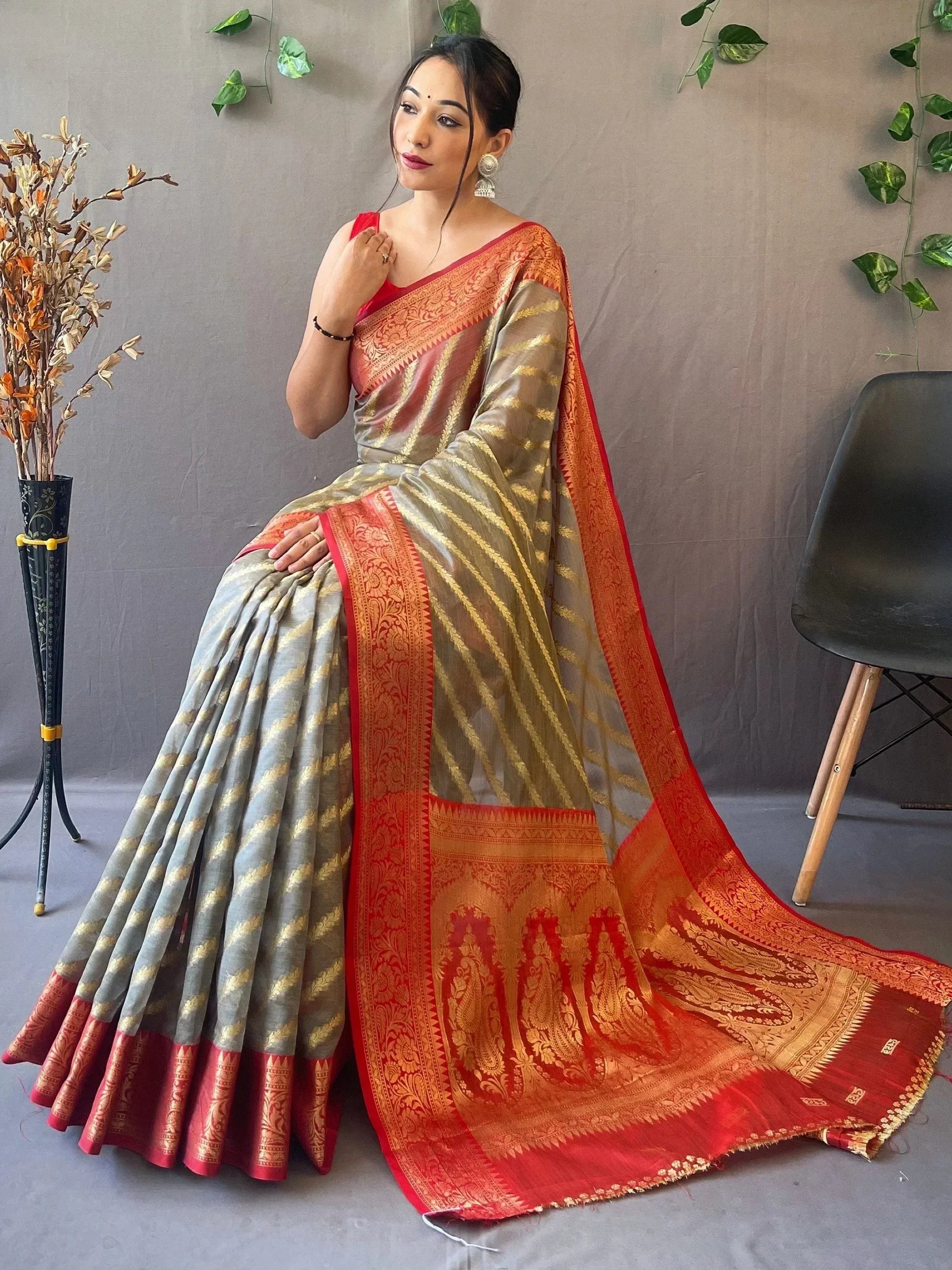 Woman in elegant grey and red designer saree with gold zari work, perfect for Indian ethnic occasions