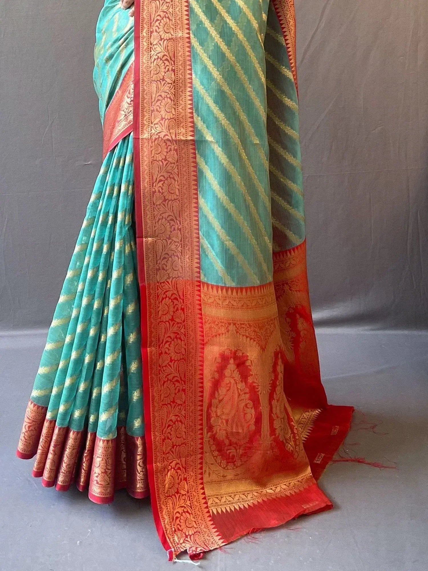 Teal and red designer saree with gold stripes and intricate border, perfect for ethnic occasions