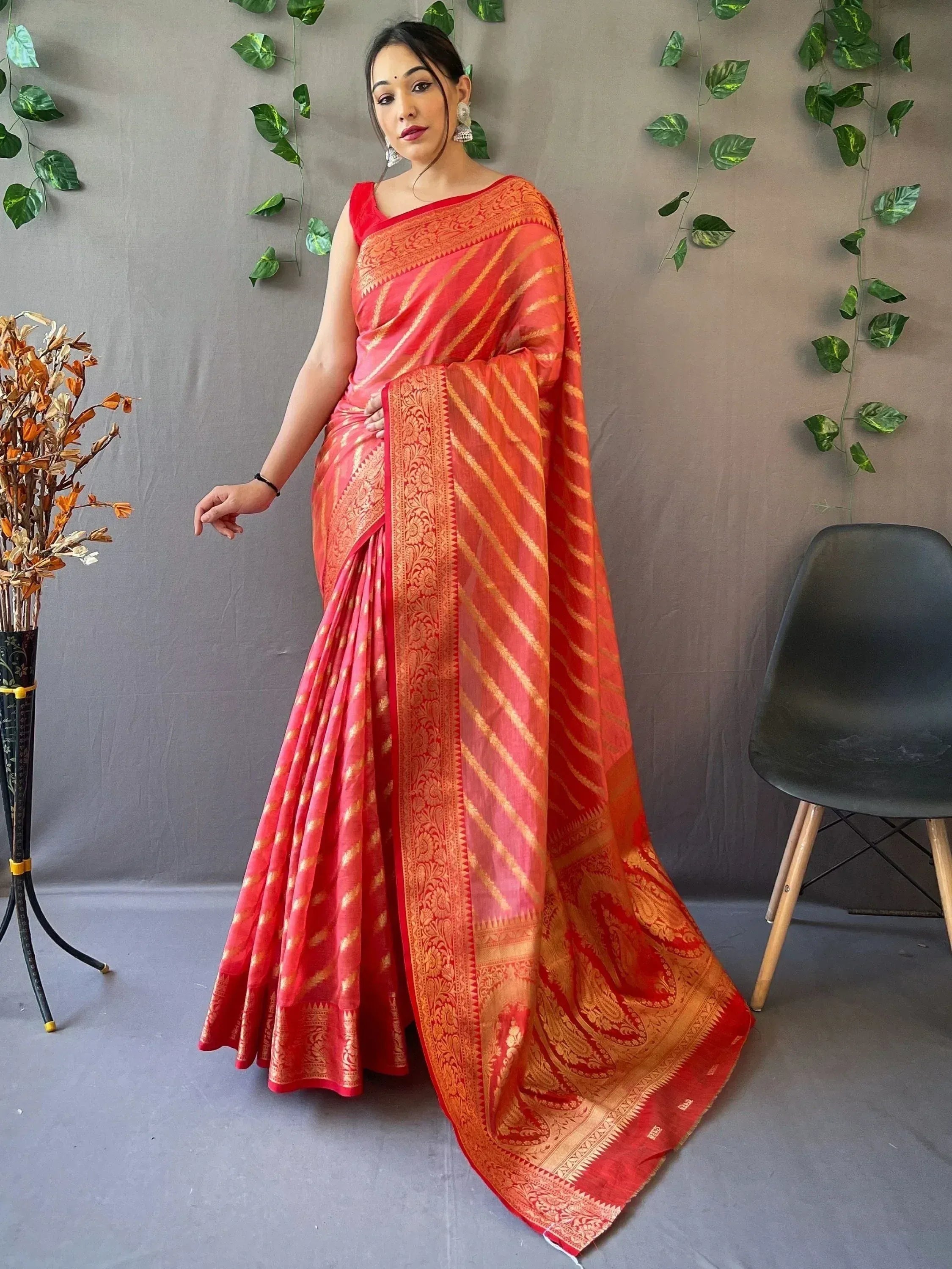 Red and gold designer saree with intricate woven patterns, perfect for ethnic occasions
