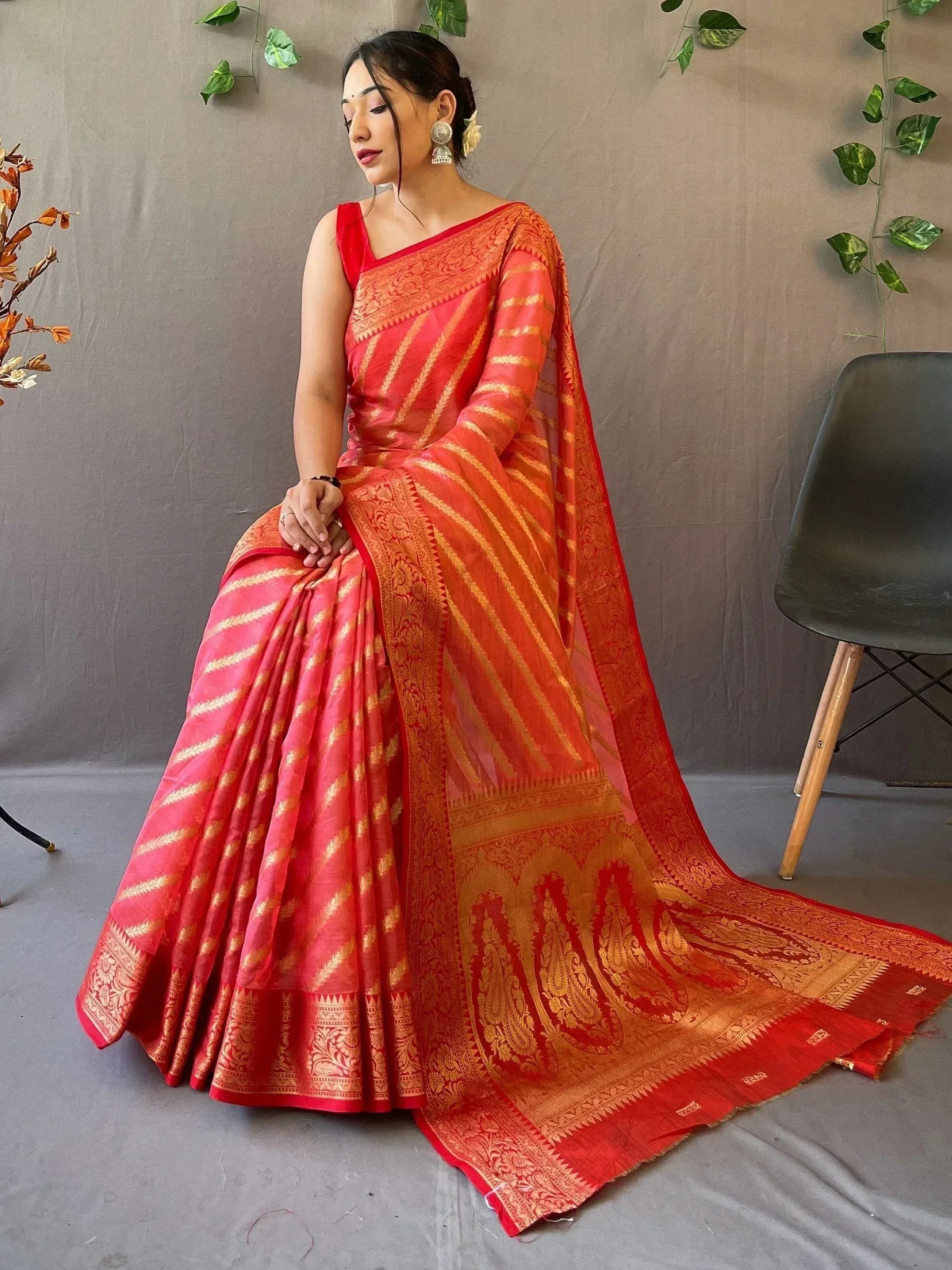 Red and gold designer saree with intricate paisley border, perfect for Indian ethnic wear occasions