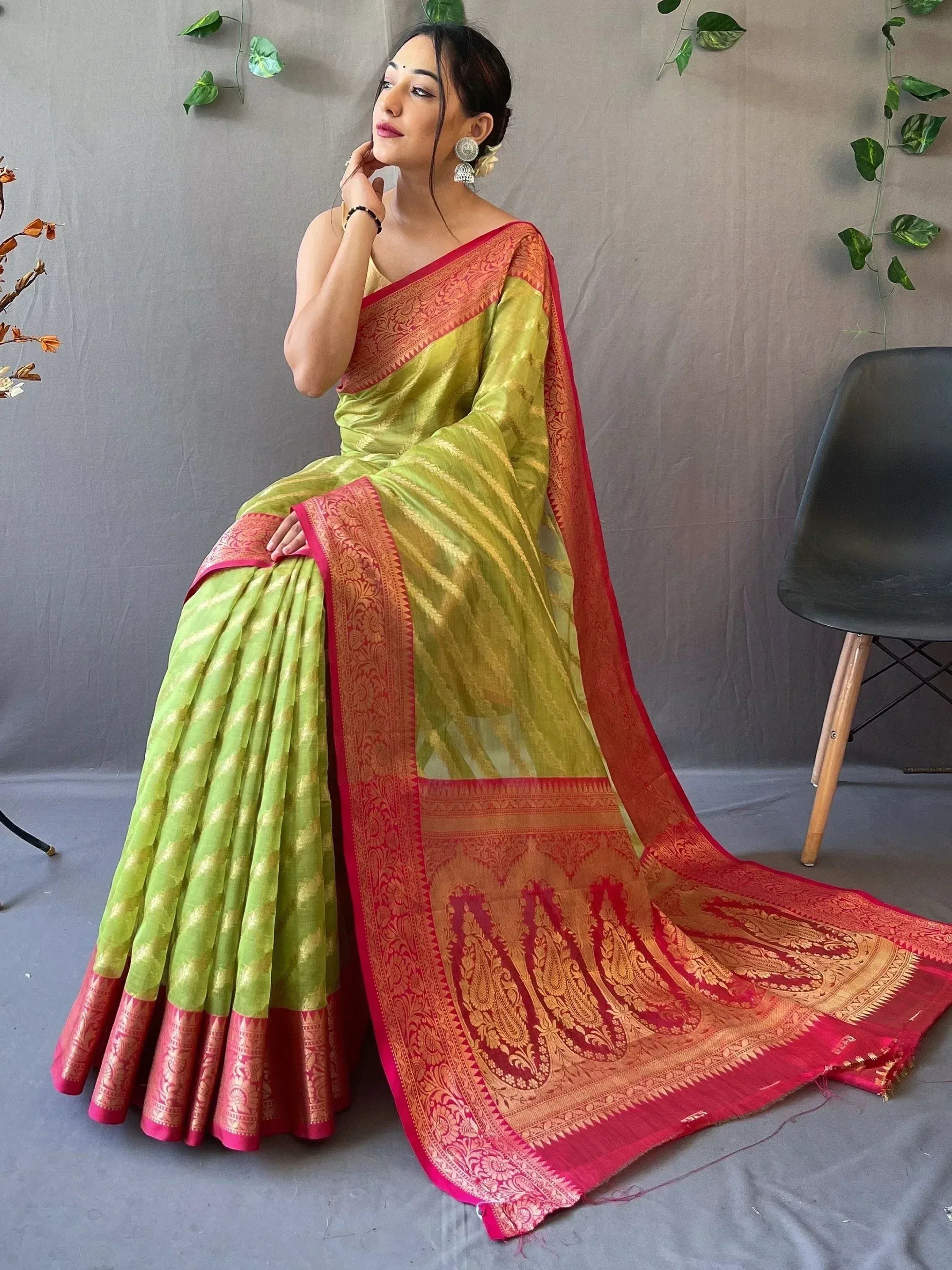 Lime green and red designer saree with gold zari work, perfect for ethnic occasions