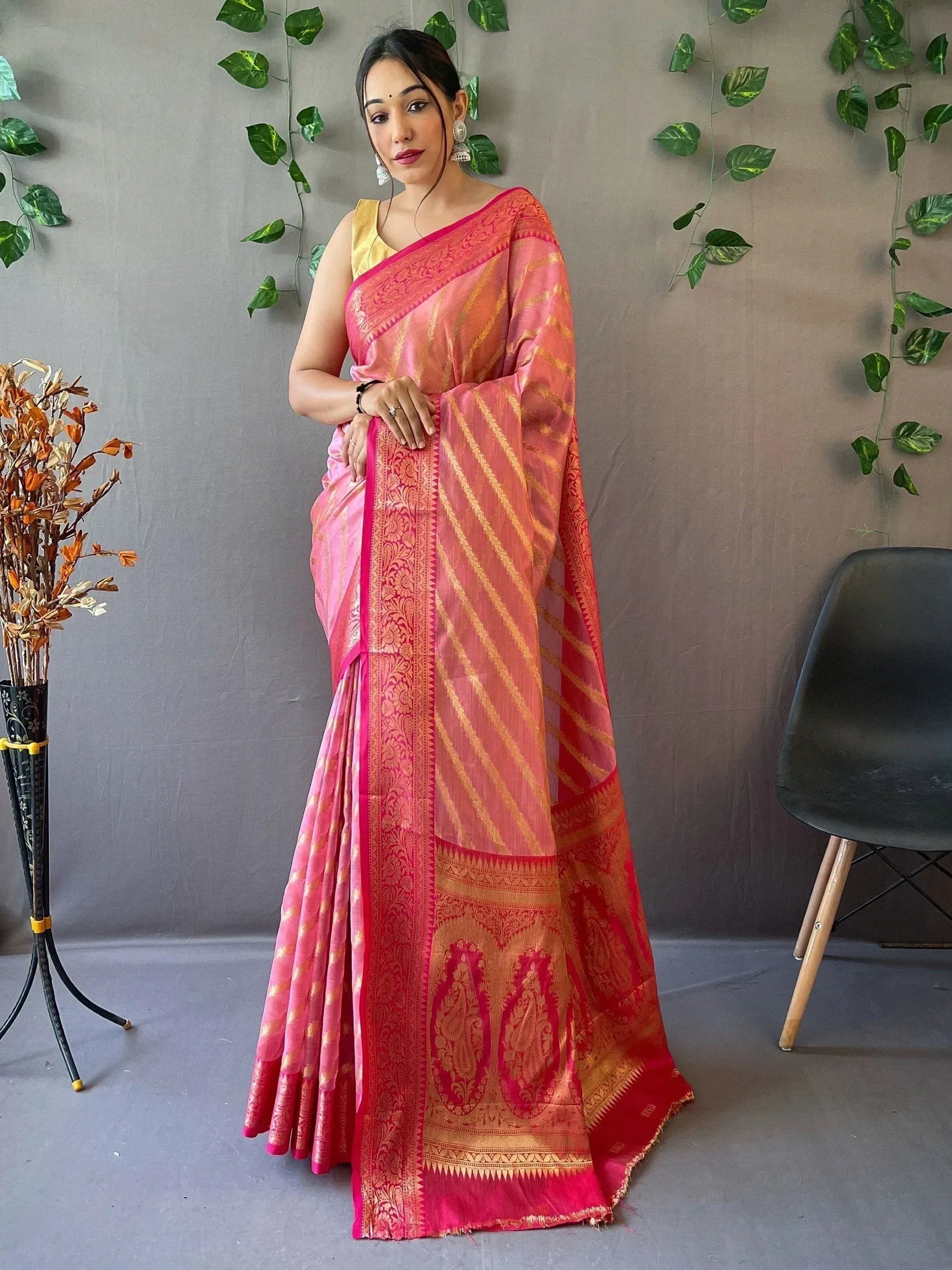 Pink and gold designer saree with intricate paisley border, perfect for Indian ethnic wear occasions
