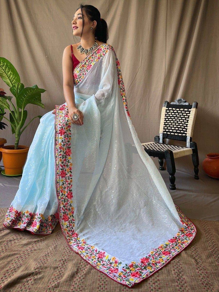 Elegant light blue saree with floral embroidery and sequin detailing, perfect for ethnic occasions.