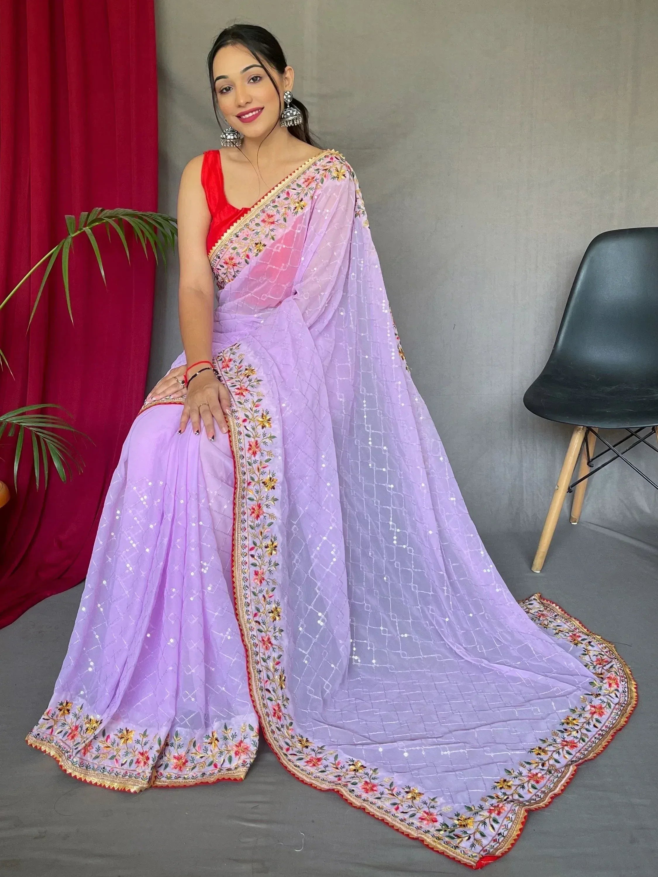 Lavender embroidered saree with red blouse, floral border, and sequin detailing for Indian ethnic wear