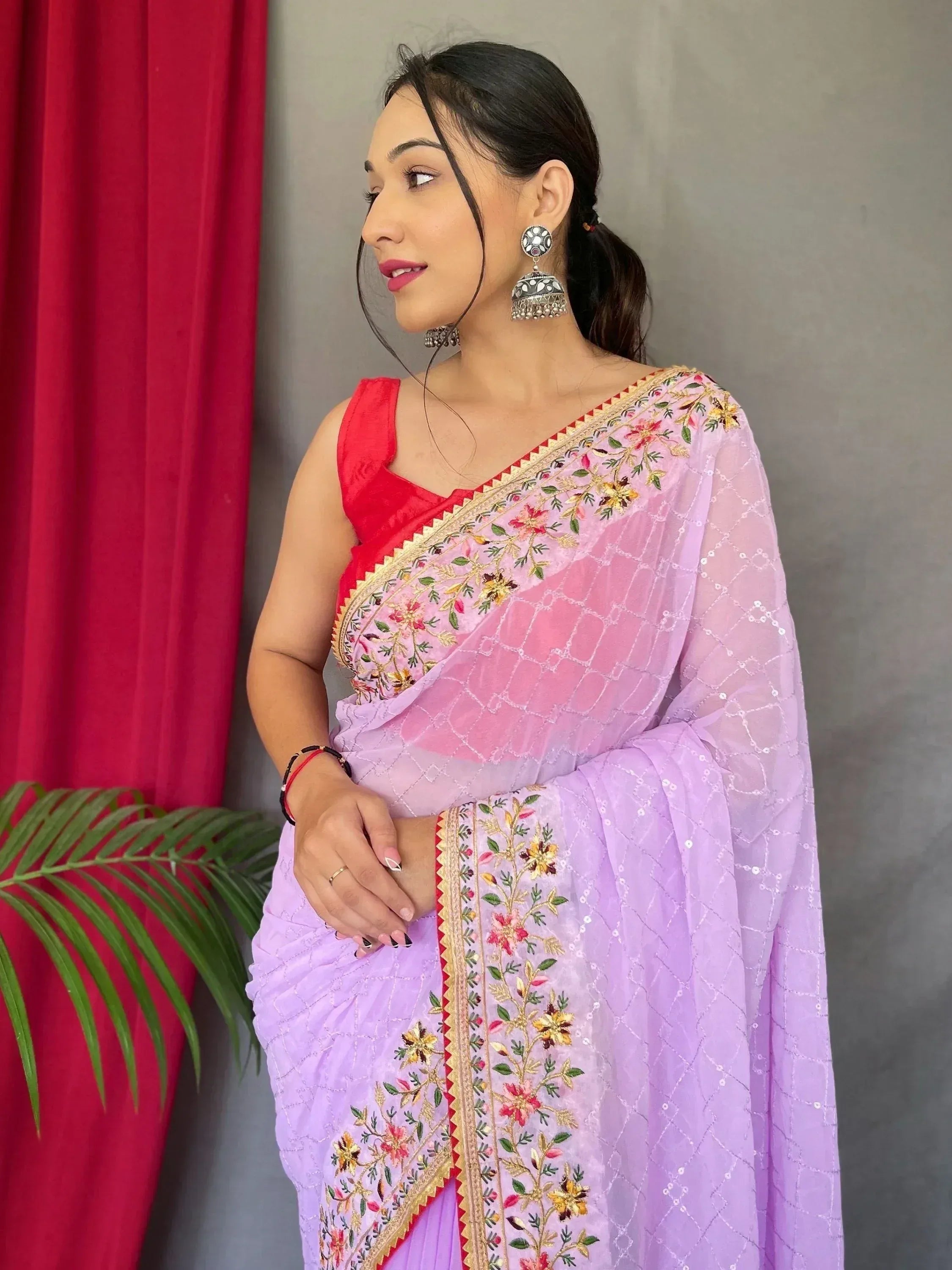 Lavender embroidered saree with red blouse, floral detailing and jhumka earrings for Indian ethnic wear