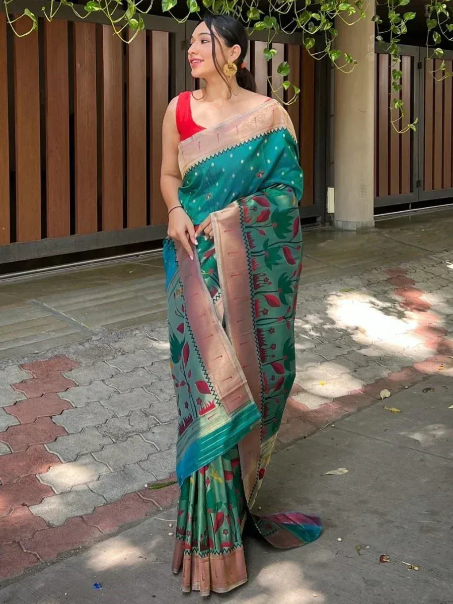 Woman in teal floral saree with red blouse, ethnic Indian wear for festive occasions