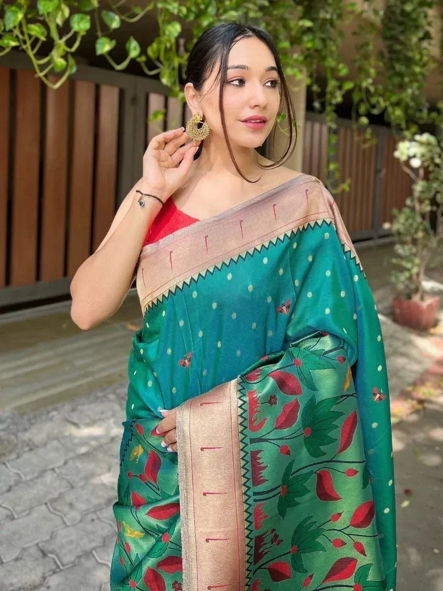 Woman in green floral saree with gold border, red blouse, and traditional earrings for ethnic wear