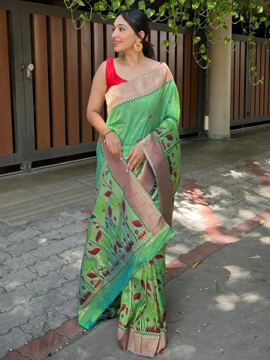 Woman in green printed saree with red blouse, ethnic Indian wear for festive occasions