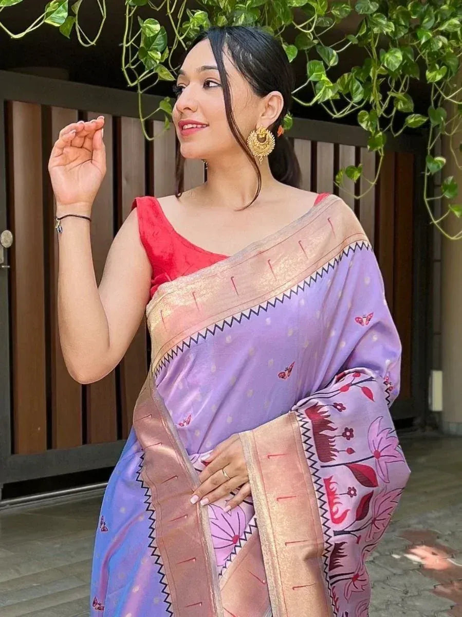 Woman in purple floral saree with gold border and red blouse, styled for ethnic occasions
