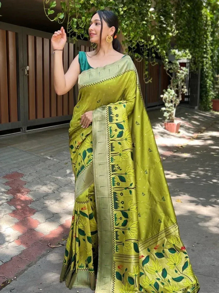 Woman in vibrant green floral print saree with embroidered border, styled for ethnic occasions