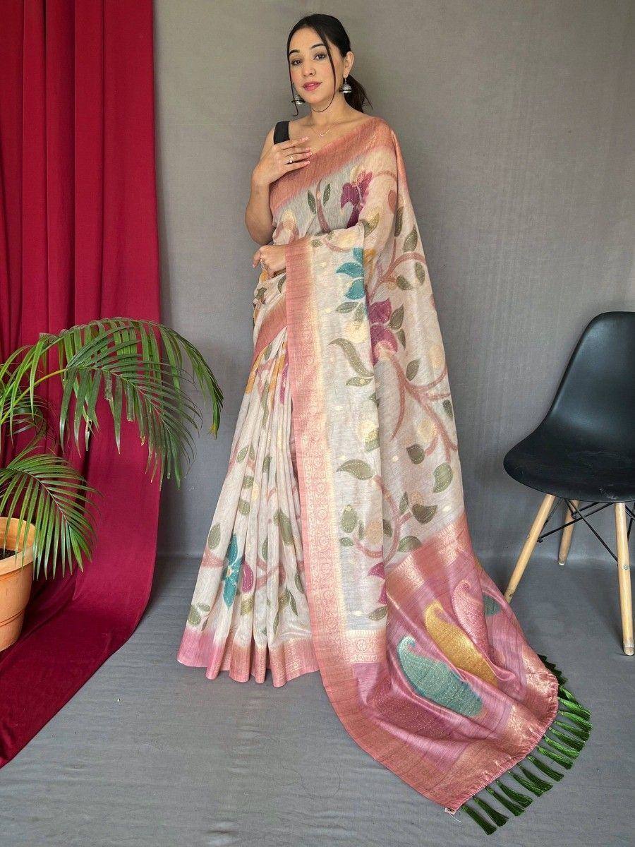 Woman in floral print saree with pink border and green tassels, styled for ethnic occasions