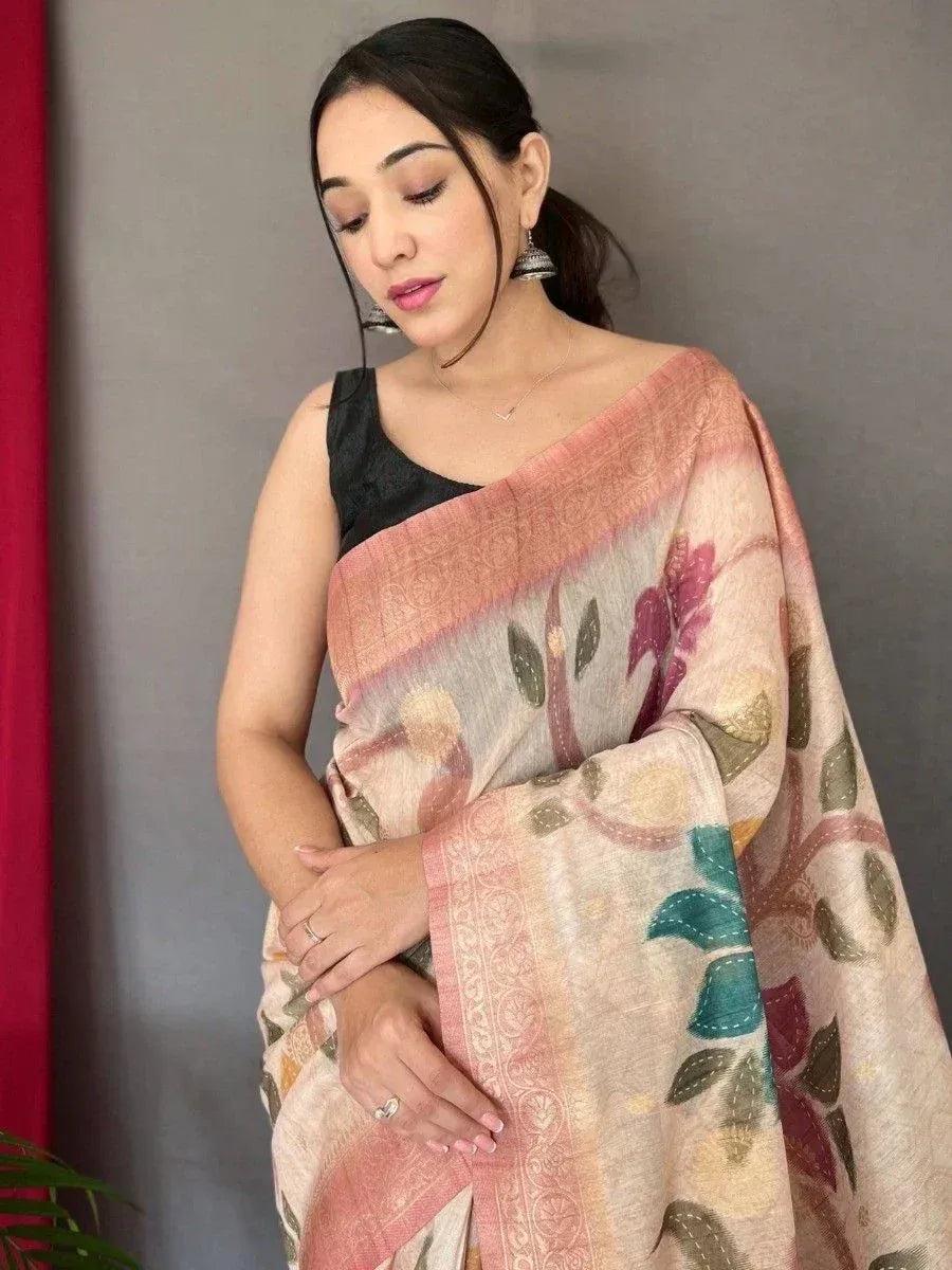 Woman in floral printed saree with pink border, paired with black blouse, ethnic Indian wear