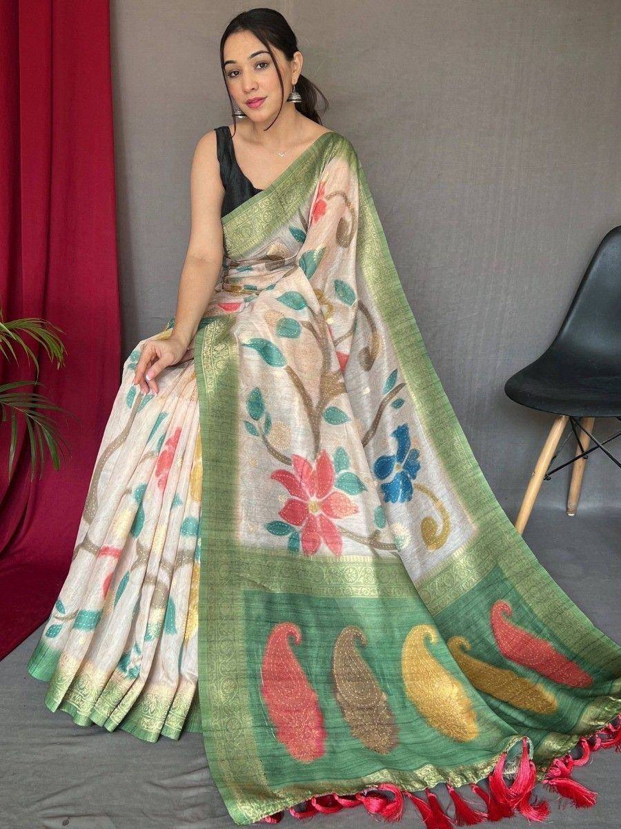 Woman in floral printed saree with green border and paisley motifs, ideal for ethnic occasions