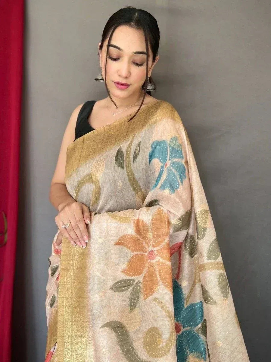 Woman in floral printed ethnic saree with gold border, styled with black blouse for traditional occasions