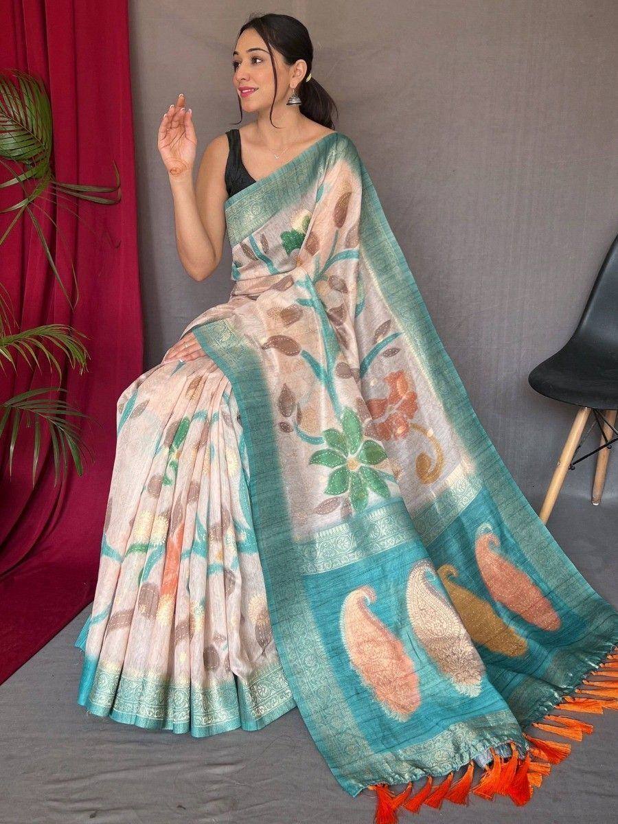 Woman in floral print saree with peacock motifs and orange tassels, ethnic Indian wear