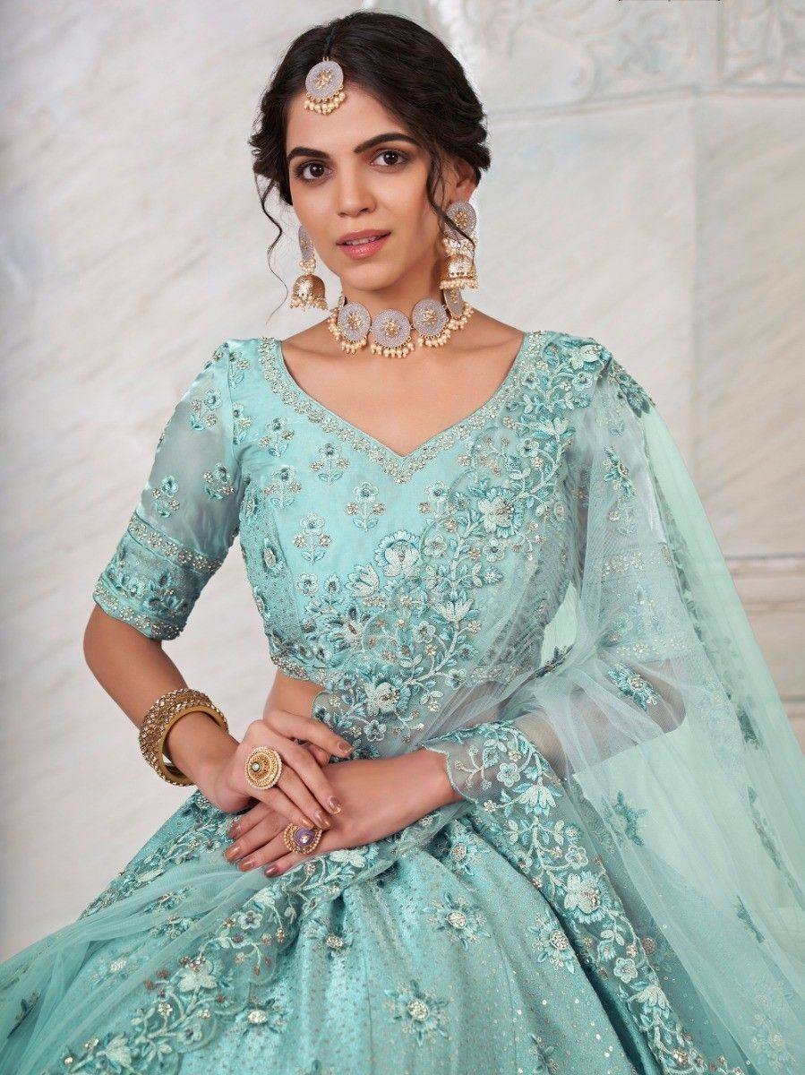 Mint green embroidered lehenga choli with floral detailing, perfect for Indian weddings and festive occasions.