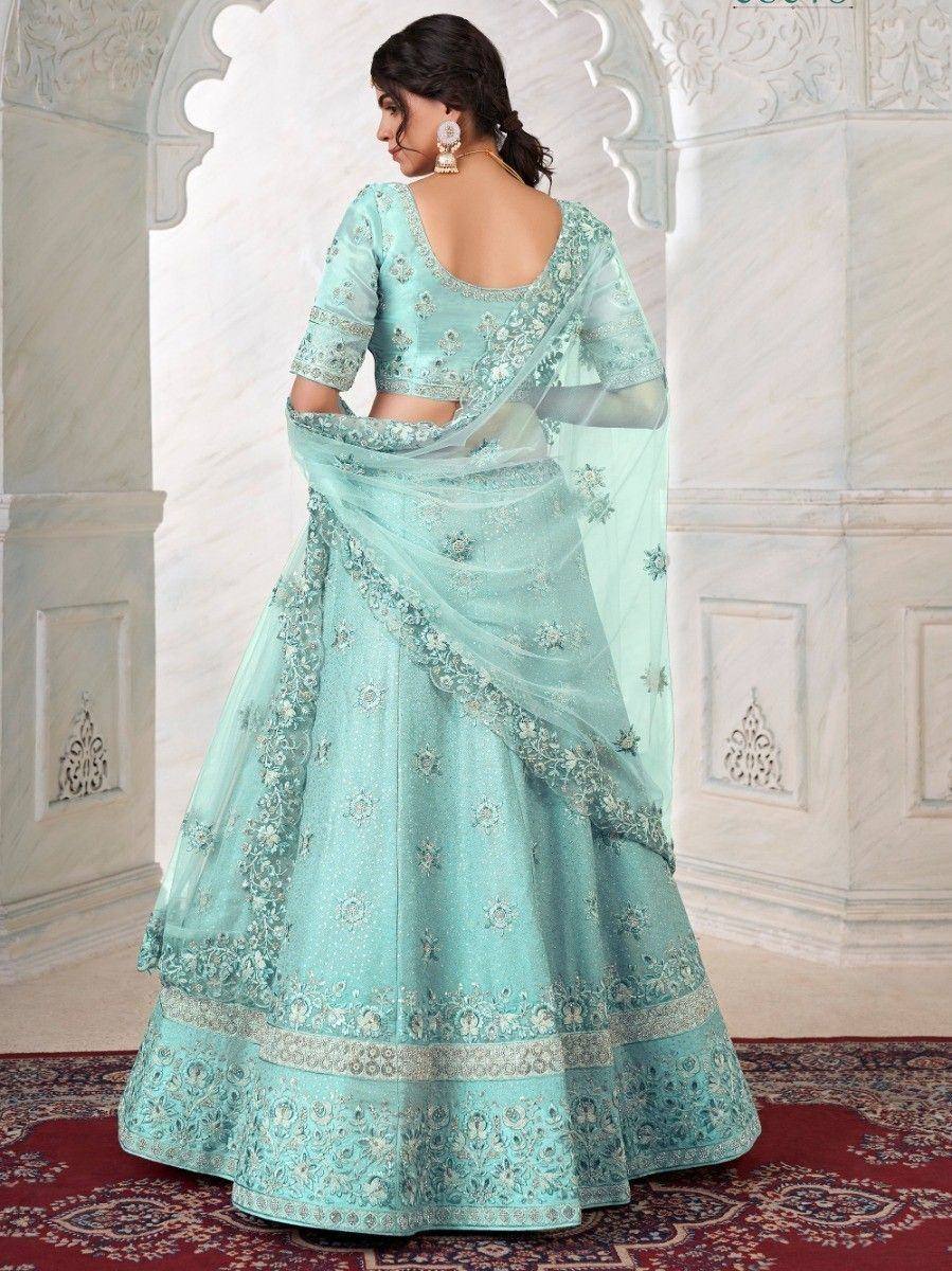 Mint green designer lehenga choli with intricate embroidery and sheer dupatta, perfect for Indian ethnic occasions.