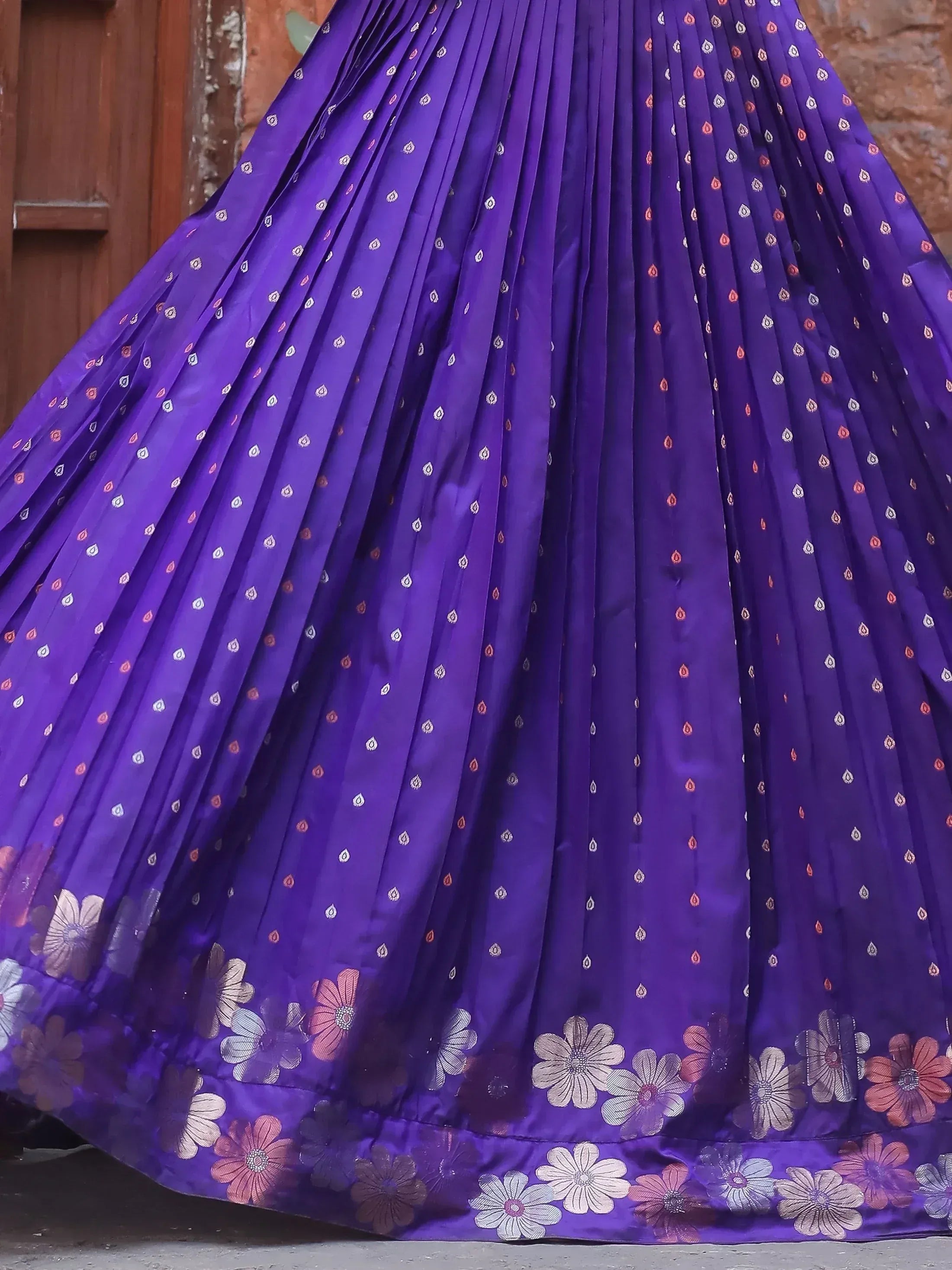 Purple pleated lehenga skirt with floral border and ethnic print, ideal for Indian weddings and festivals