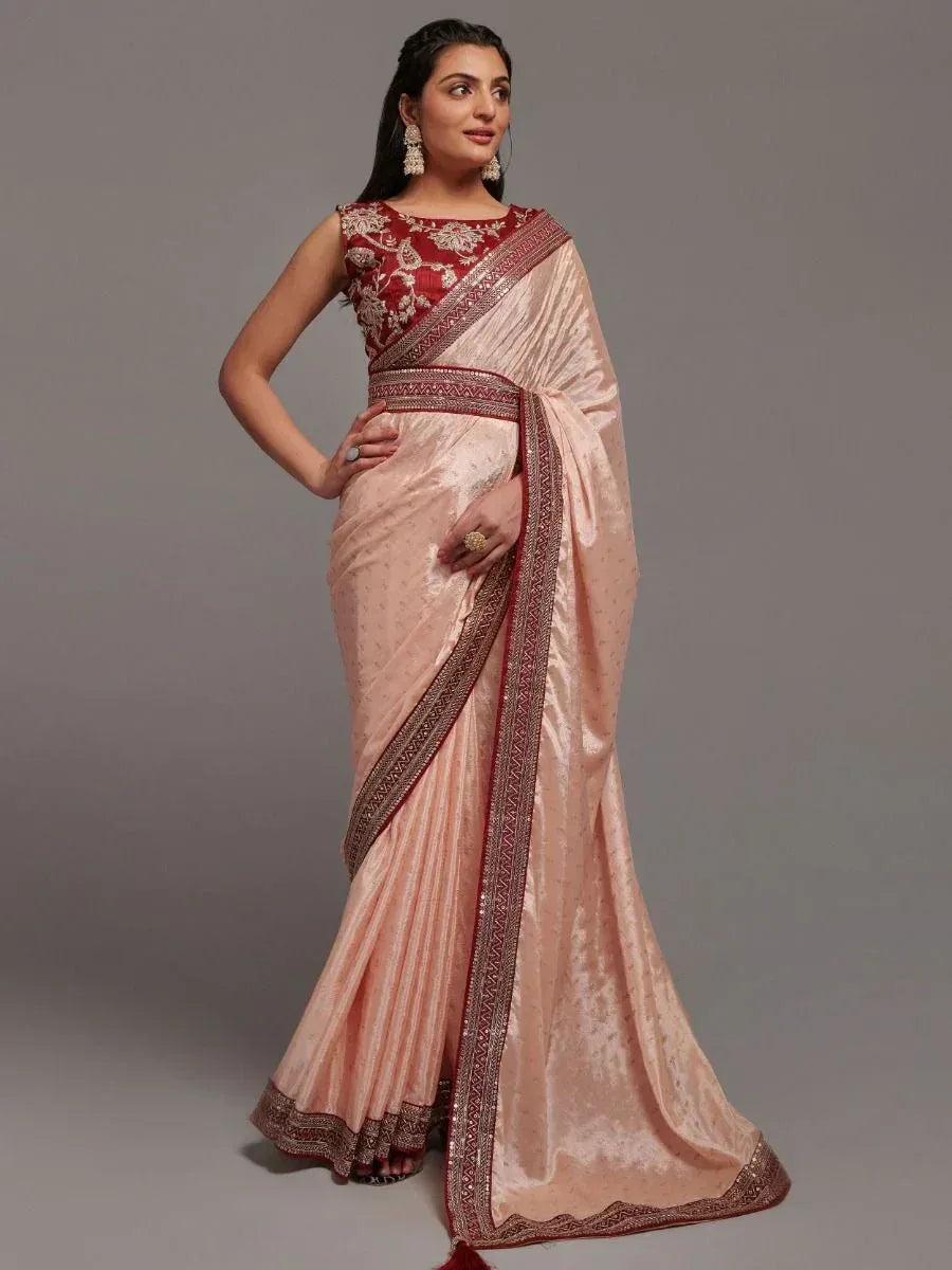 Elegant peach saree with red embroidered blouse, perfect for Indian ethnic wear occasions
