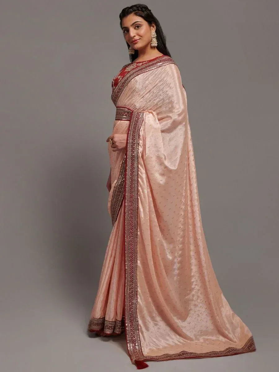 Elegant peach saree with red border, perfect for ethnic occasions and festive wear.