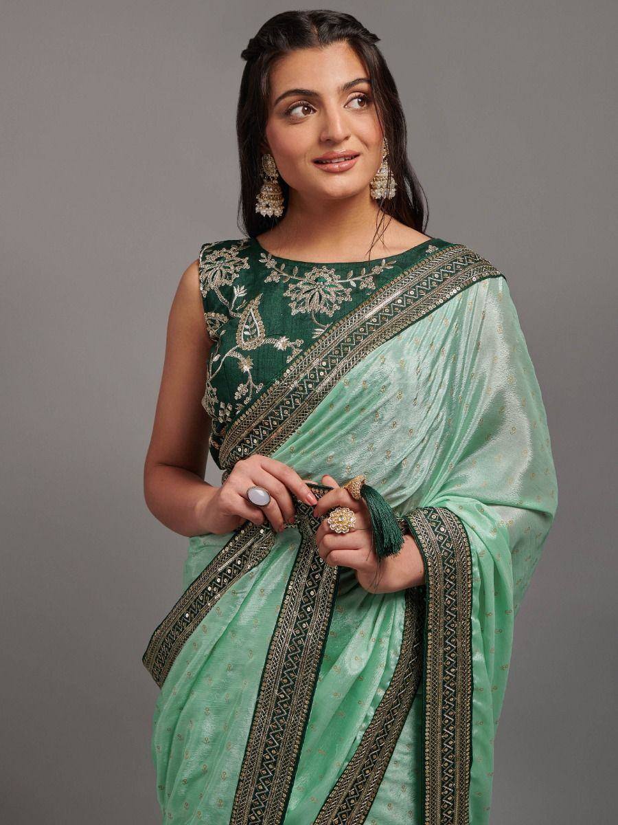 Elegant green embroidered saree with gold detailing, perfect for Indian ethnic occasions.