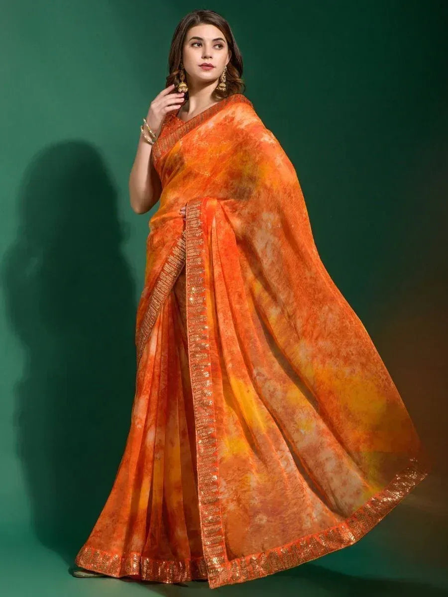 Orange tie-dye saree with golden border, styled for Indian ethnic wear