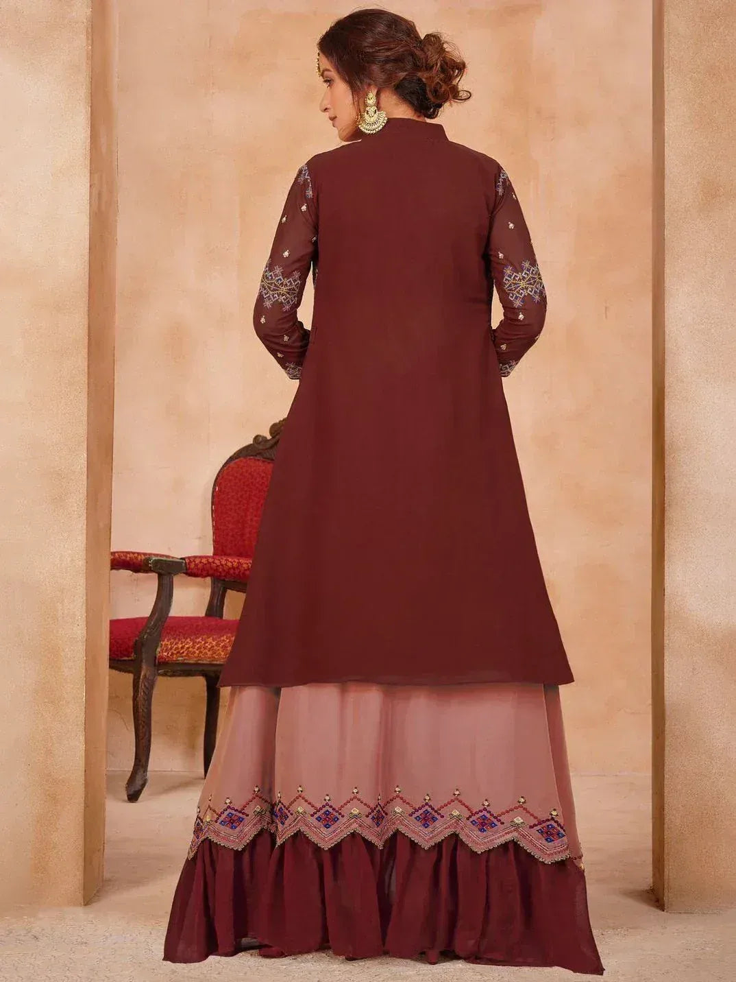 Maroon ethnic gown with embroidered sleeves and hem, paired with matching skirt for festive occasions