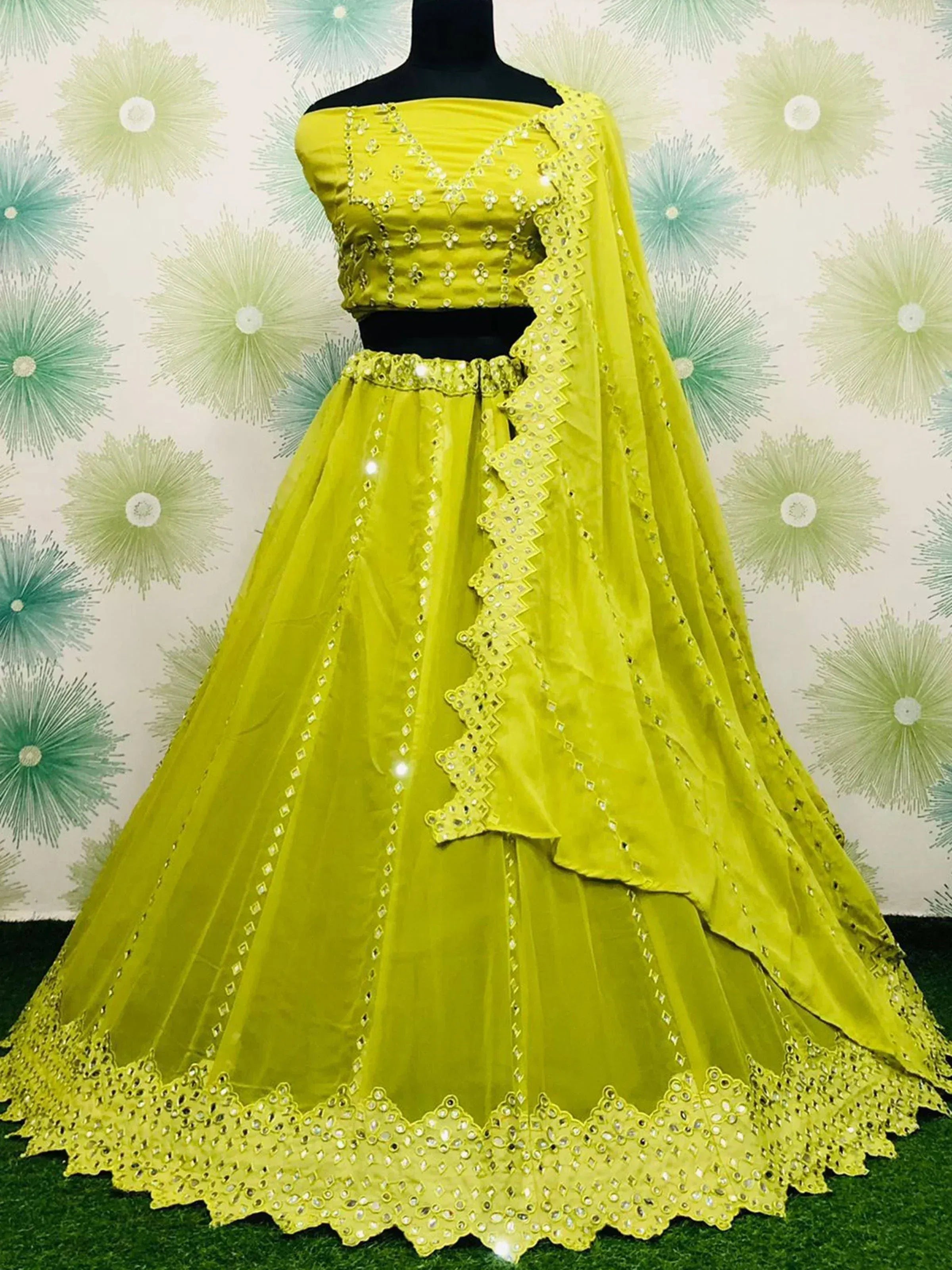 Vibrant yellow designer lehenga choli with mirror work, perfect for Indian ethnic wear events.