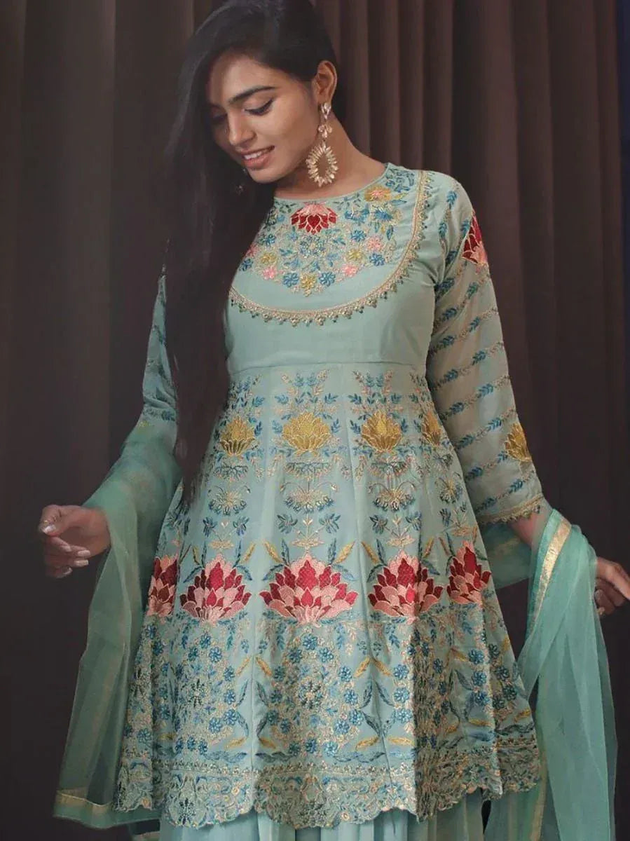 Woman in light blue floral embroidered ethnic gown with sheer dupatta