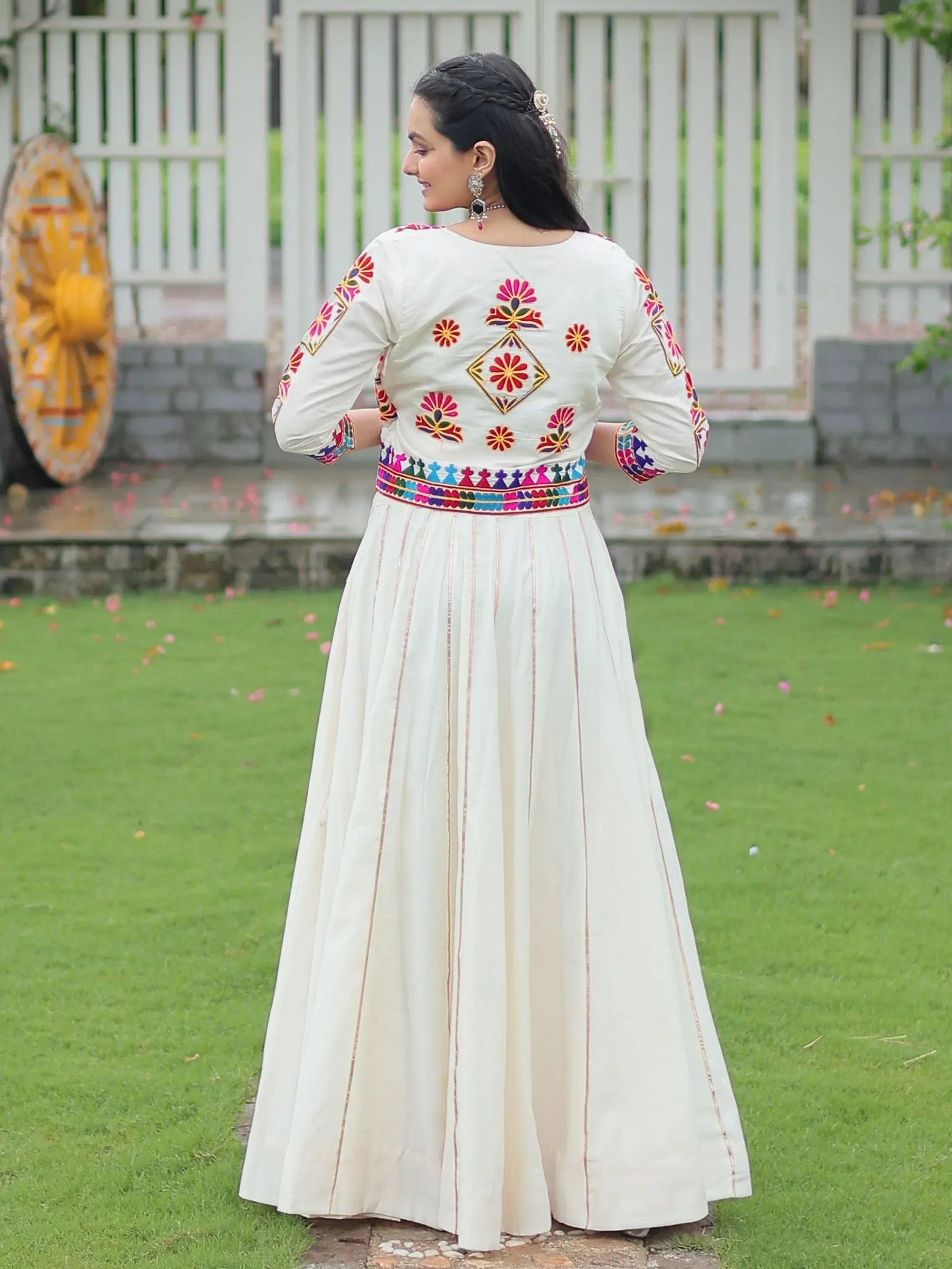 White ethnic gown with colorful floral embroidery, perfect for Indian occasions and festivals