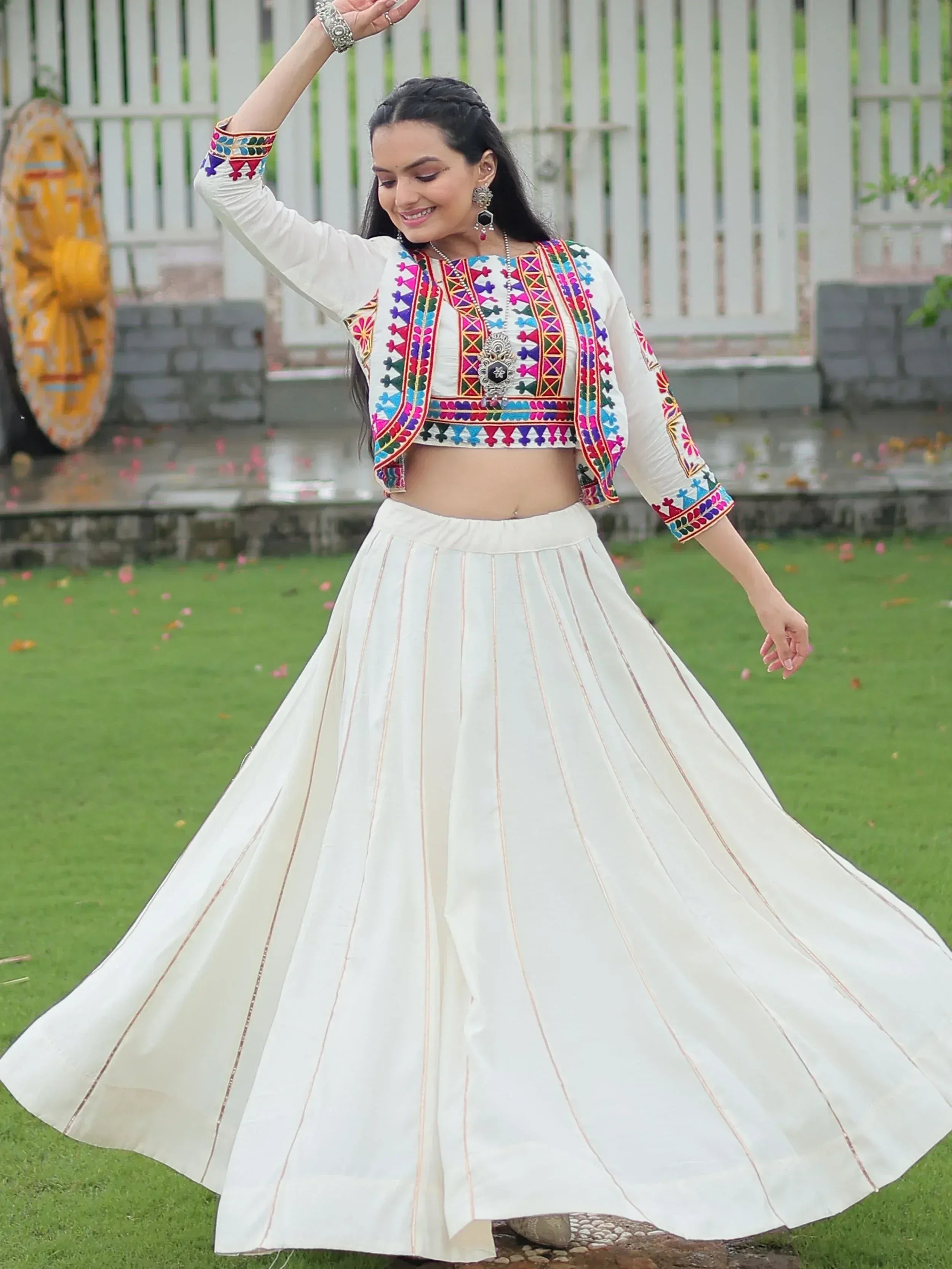 White embroidered lehenga choli with colorful mirror work, perfect for Indian ethnic wear and festive occasions.