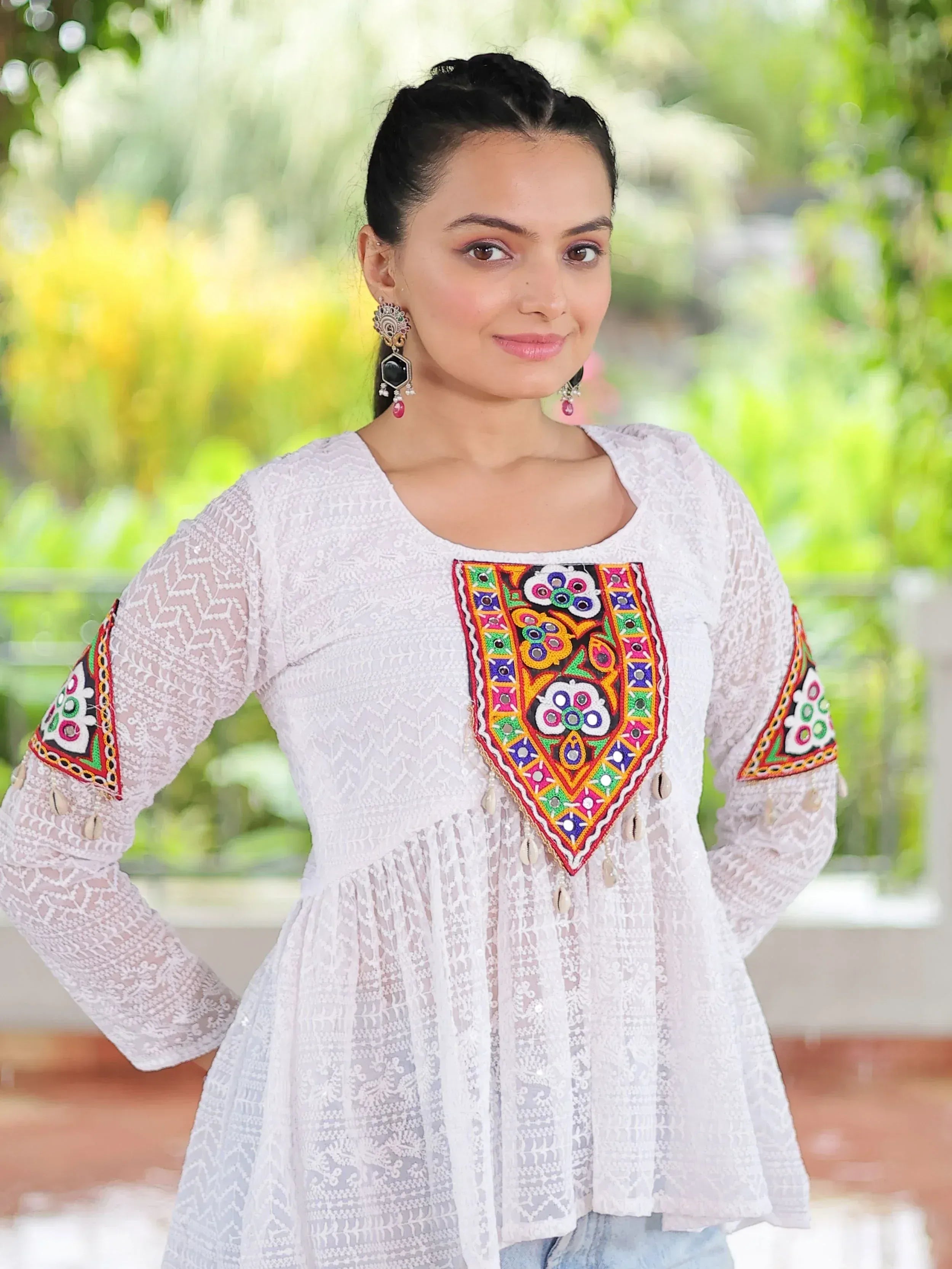 White ethnic kurta with colorful mirror embroidery and lace detailing, perfect for Indian festive wear