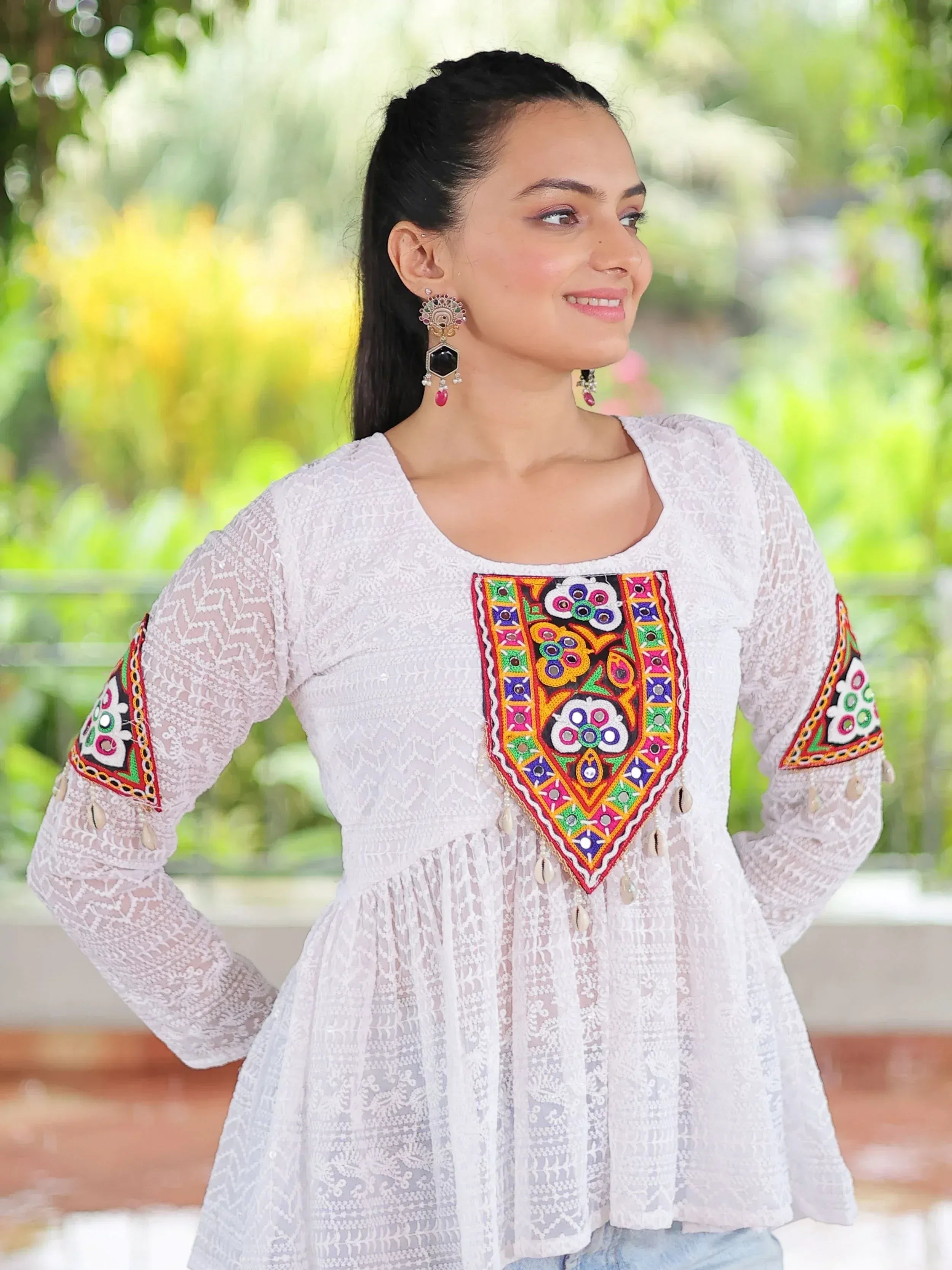 White ethnic kurti with colorful mirror embroidery and lace detailing, perfect for Indian festive wear