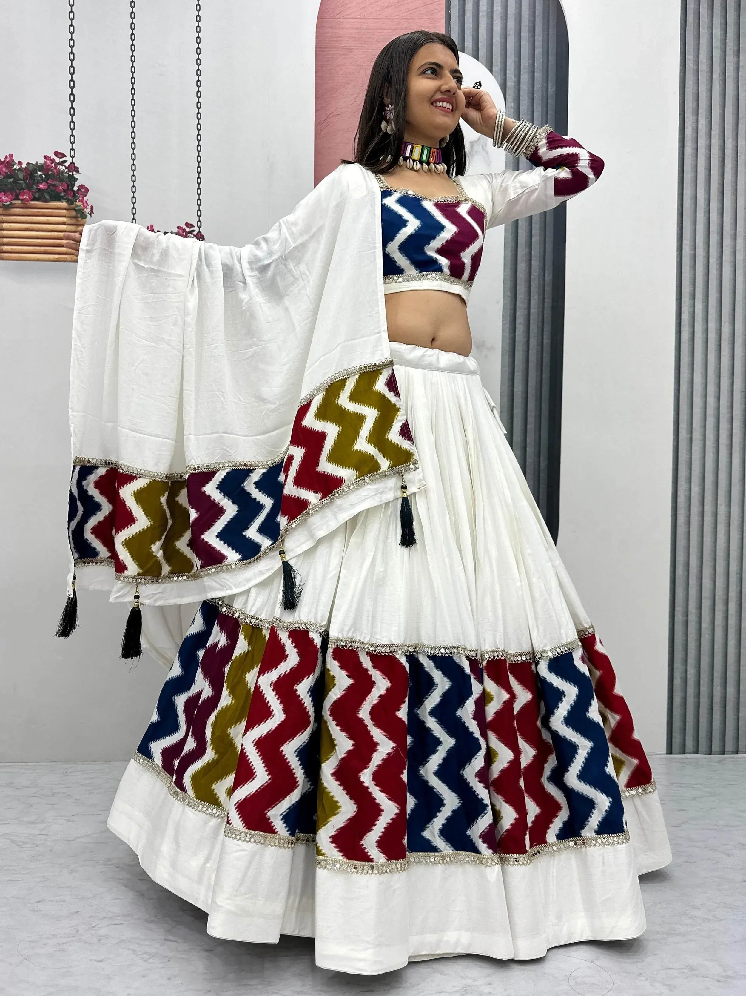 White lehenga choli with colorful zigzag print, perfect for Indian ethnic wear and festive occasions.