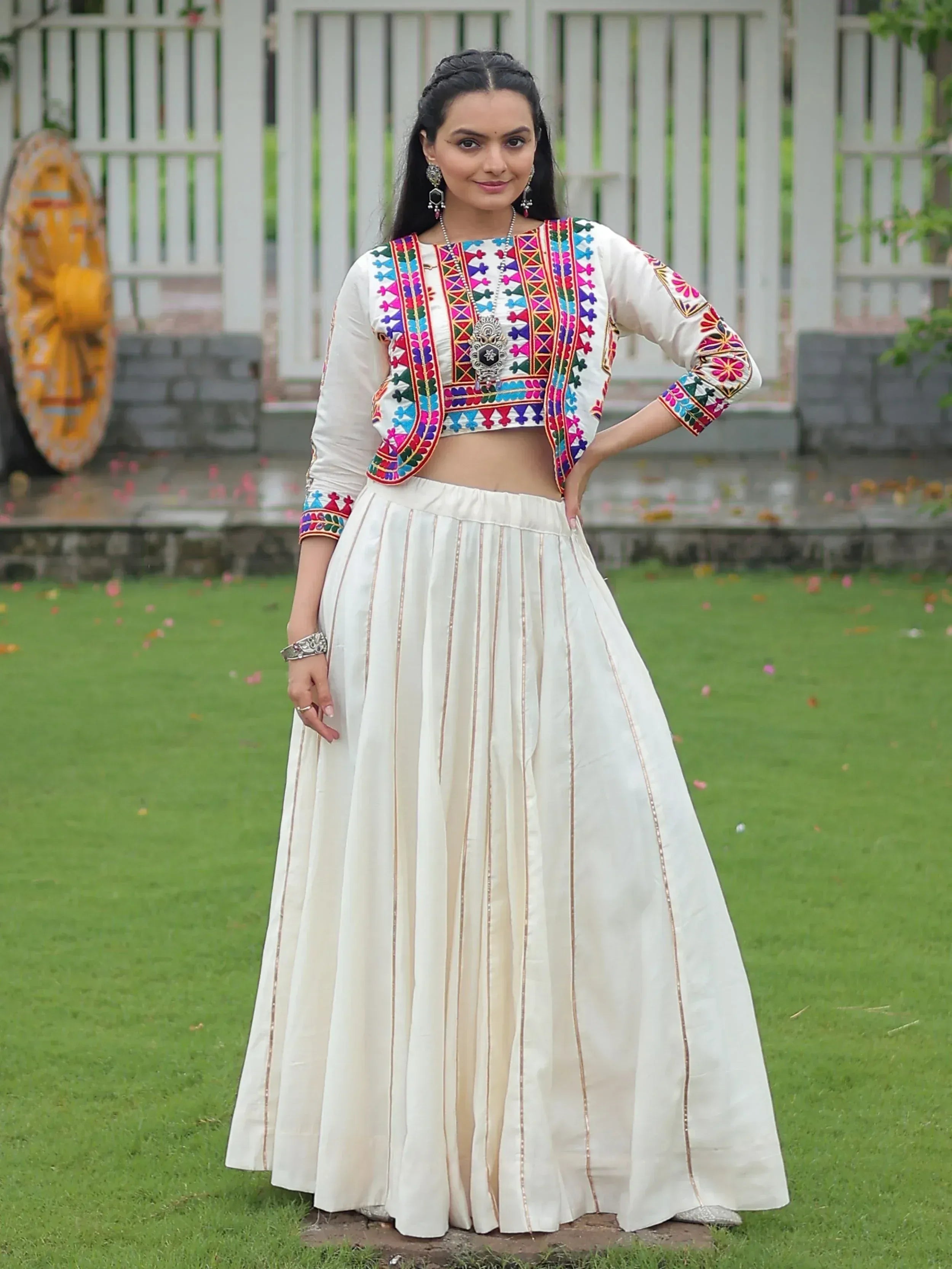 White embroidered crop top with colorful patterns and pleated skirt, Indian ethnic wear for women