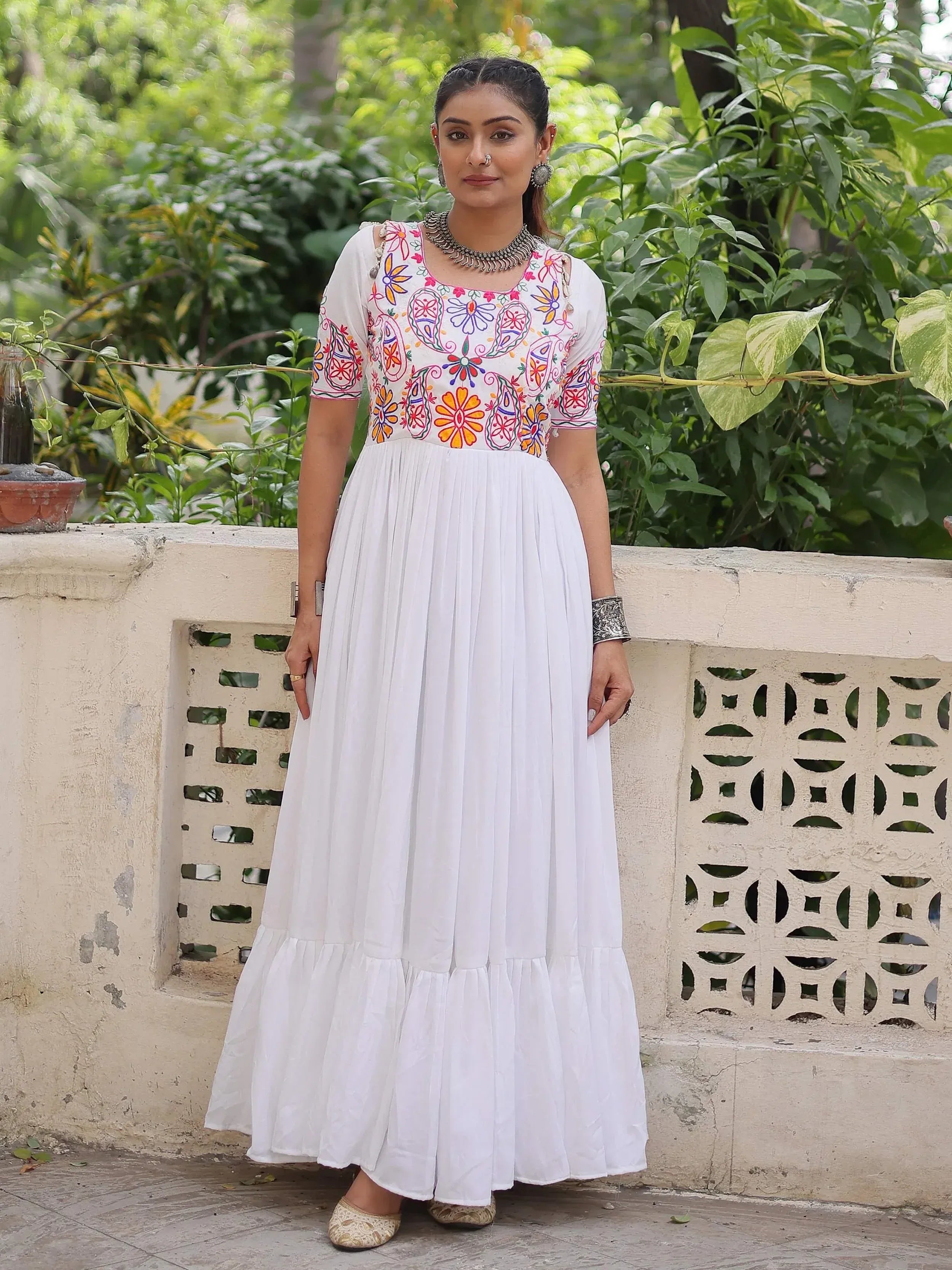 White ethnic gown with colorful floral embroidery, perfect for Indian festive wear and occasions