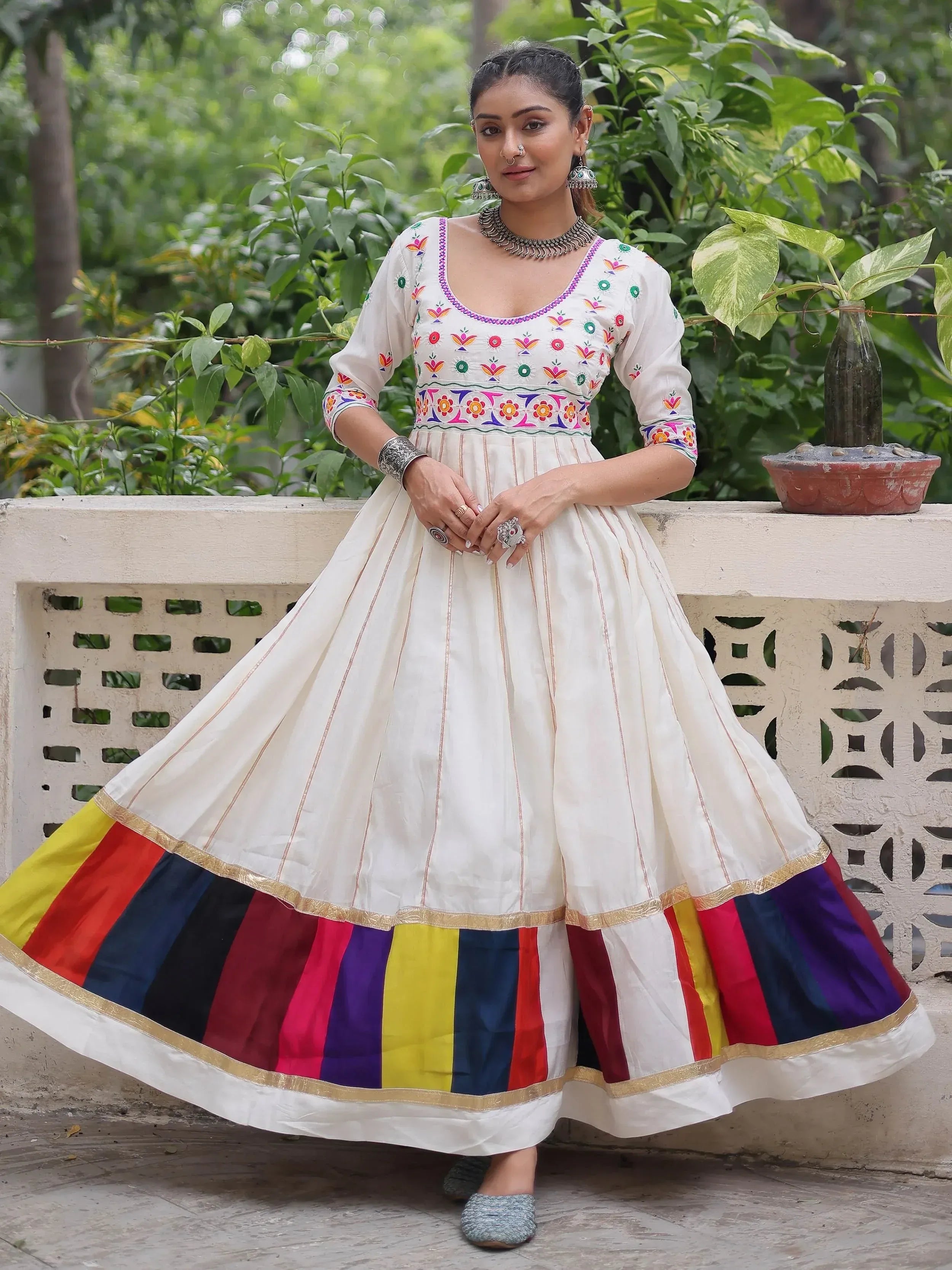 White embroidered Anarkali with colorful striped border, traditional Indian ethnic wear for women