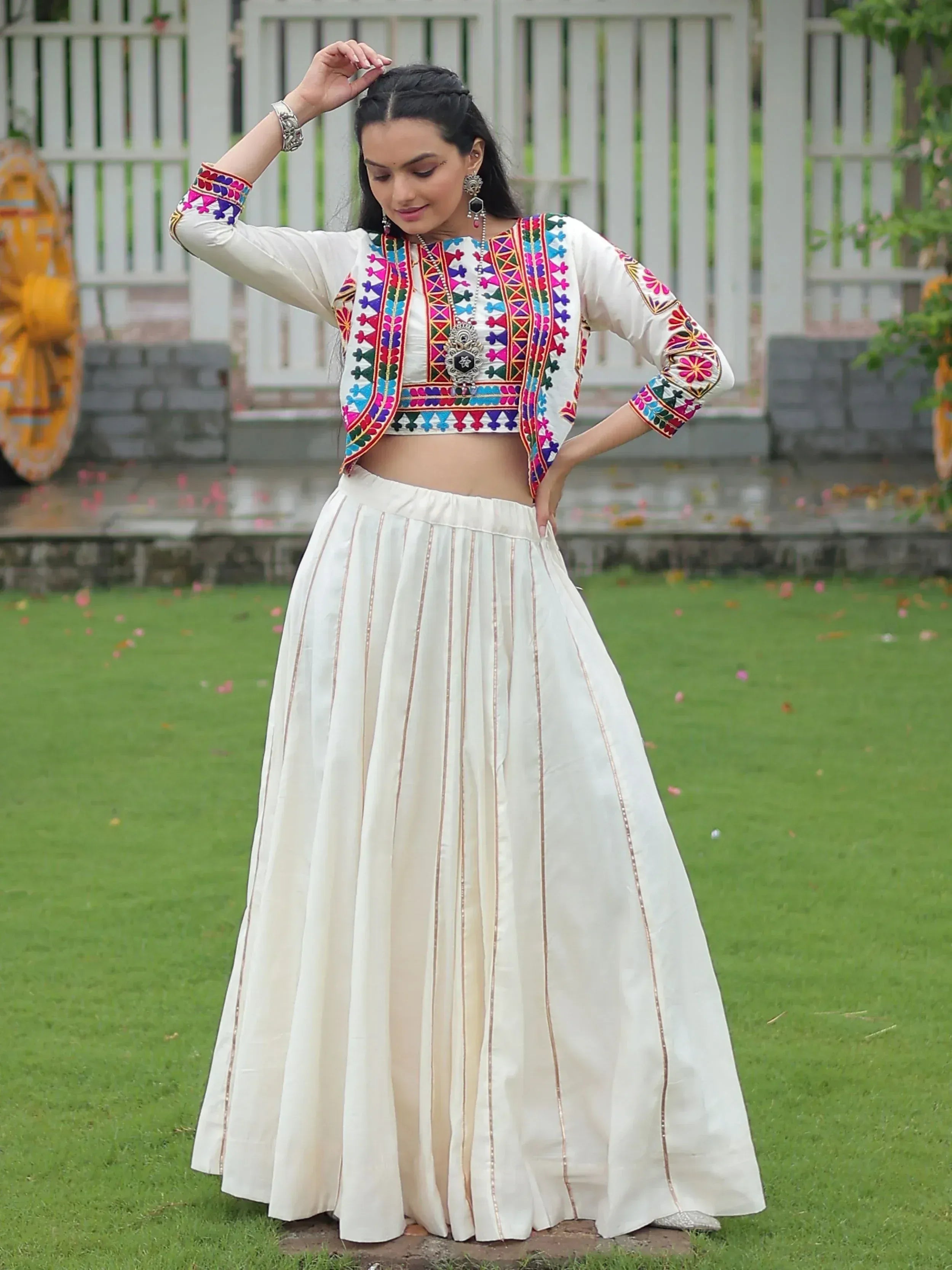 White embroidered crop top with colorful patterns and pleated skirt, Indian ethnic wear