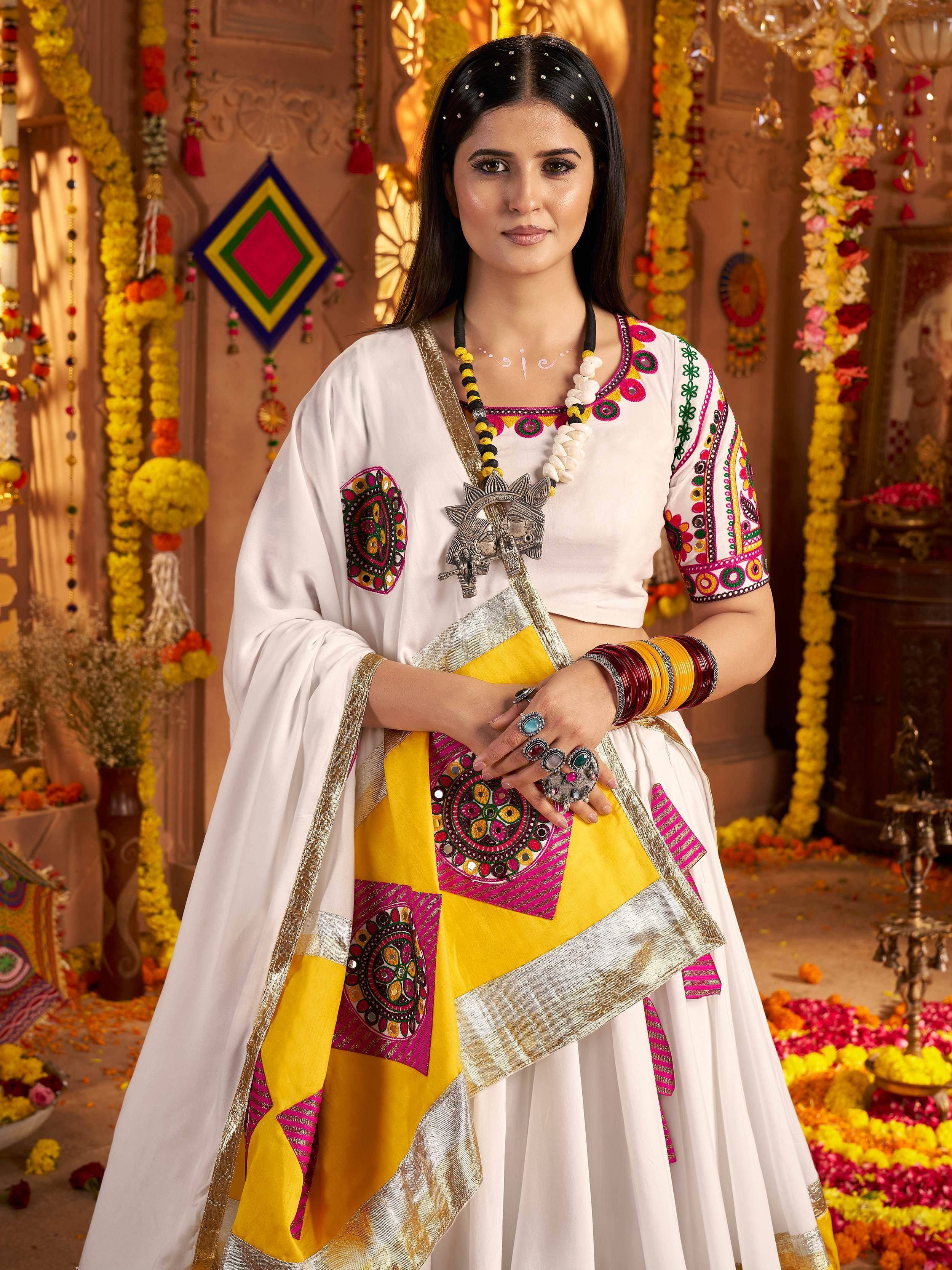 White and yellow embroidered ethnic wear with mirror work, perfect for Indian festivals and celebrations.
