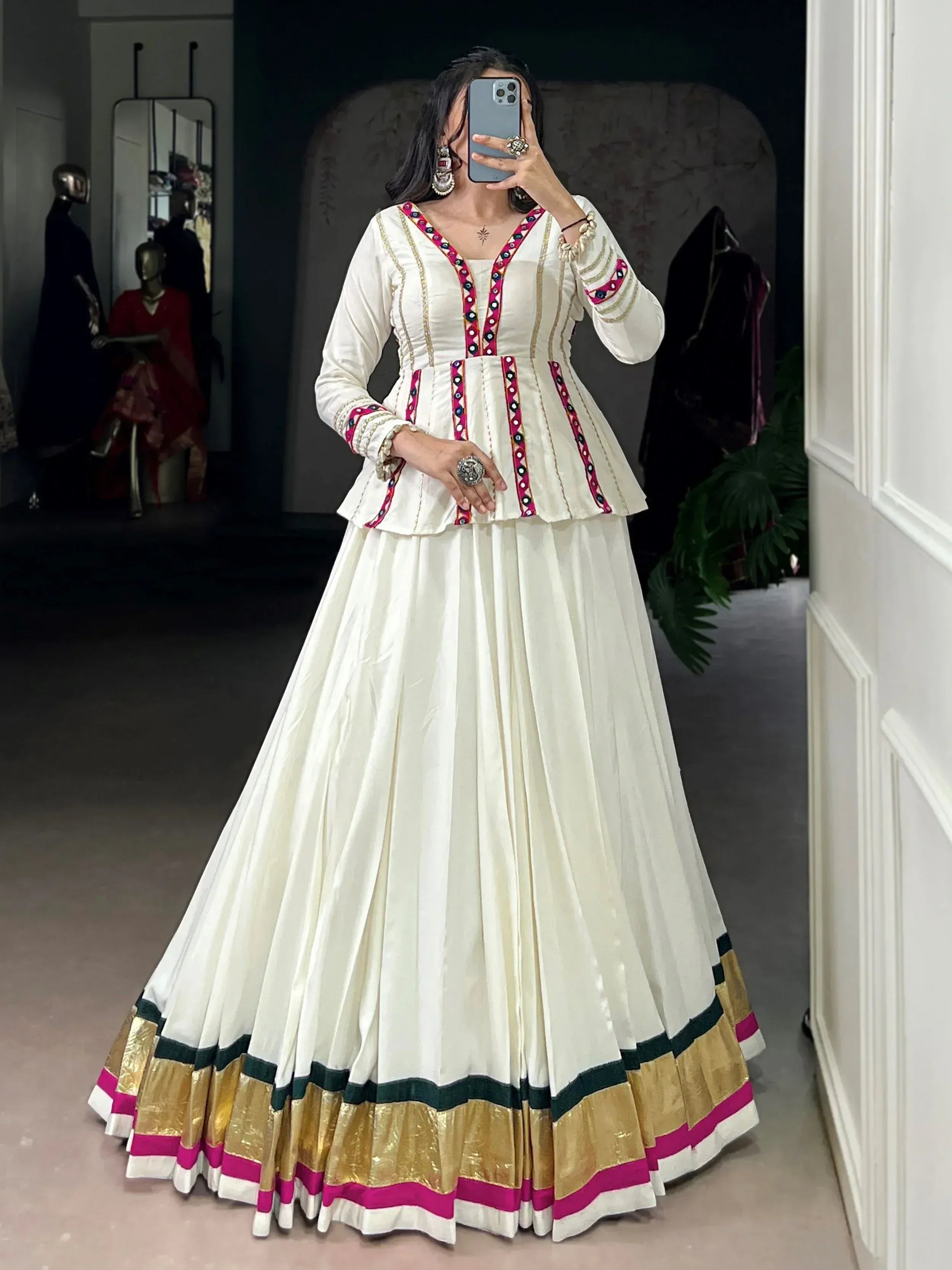 Elegant white ethnic gown with pink and gold trim, perfect for Indian festive occasions
