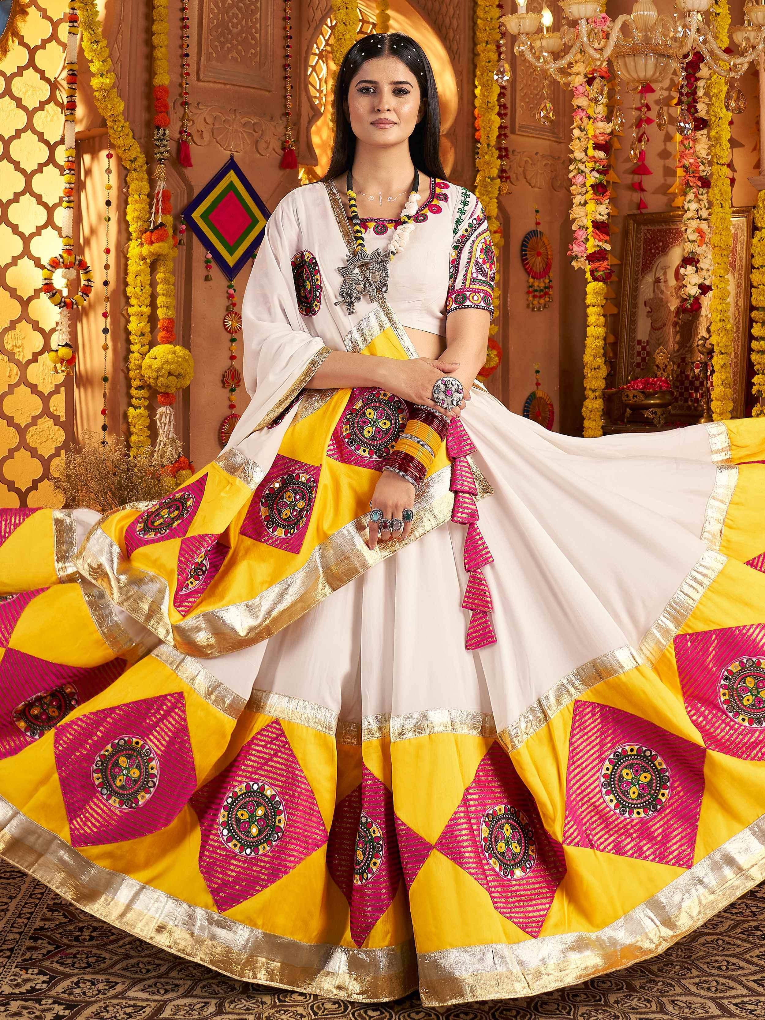 White and yellow embroidered lehenga choli with pink mirror work, perfect for Indian ethnic occasions