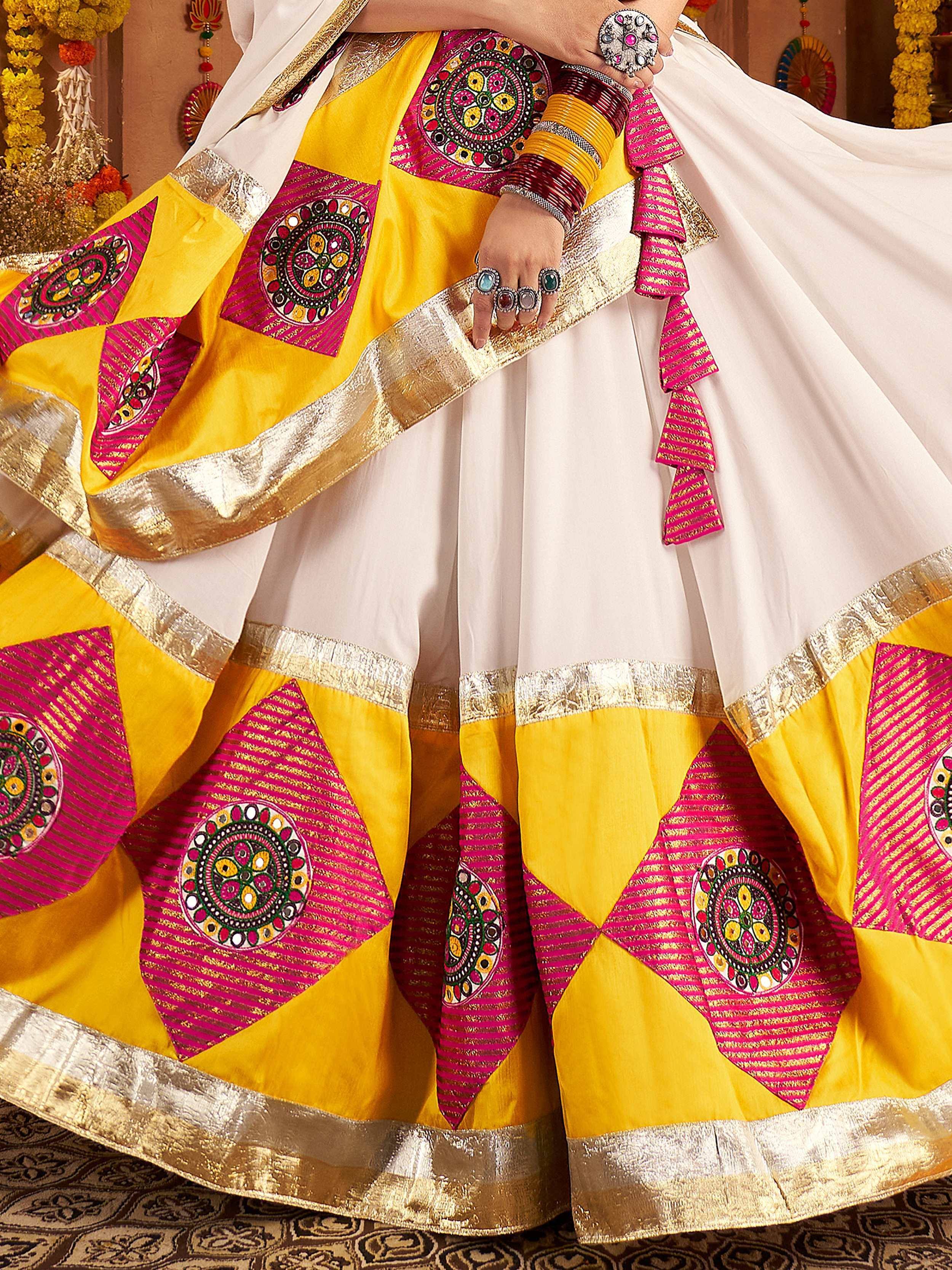 Yellow and pink embroidered ethnic lehenga with gold trim, traditional Indian wear for festive occasions