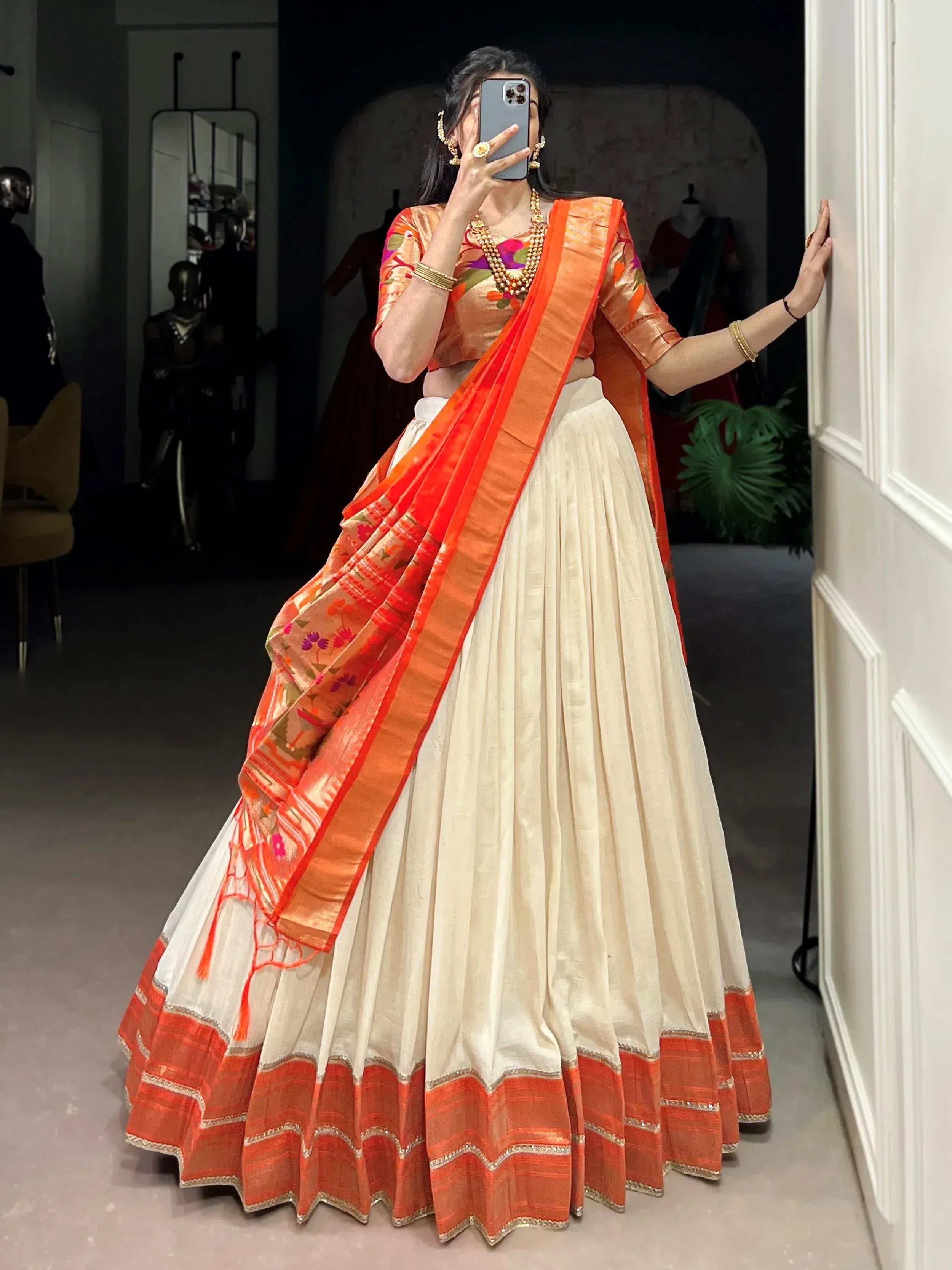 Orange floral lehenga choli with cream pleated skirt, perfect for Indian ethnic wear occasions