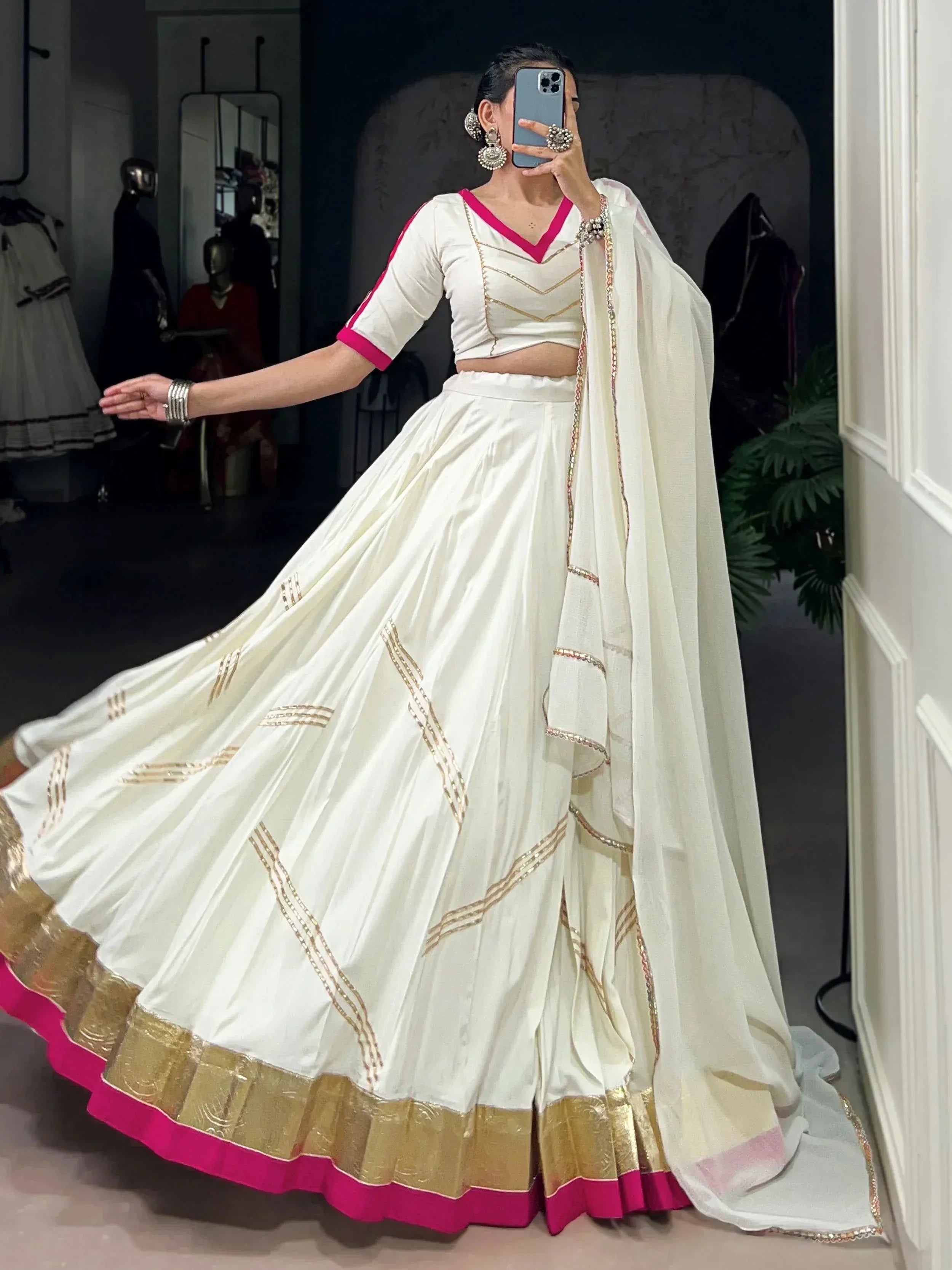 White lehenga choli with pink and gold trim, perfect for Indian ethnic wear events