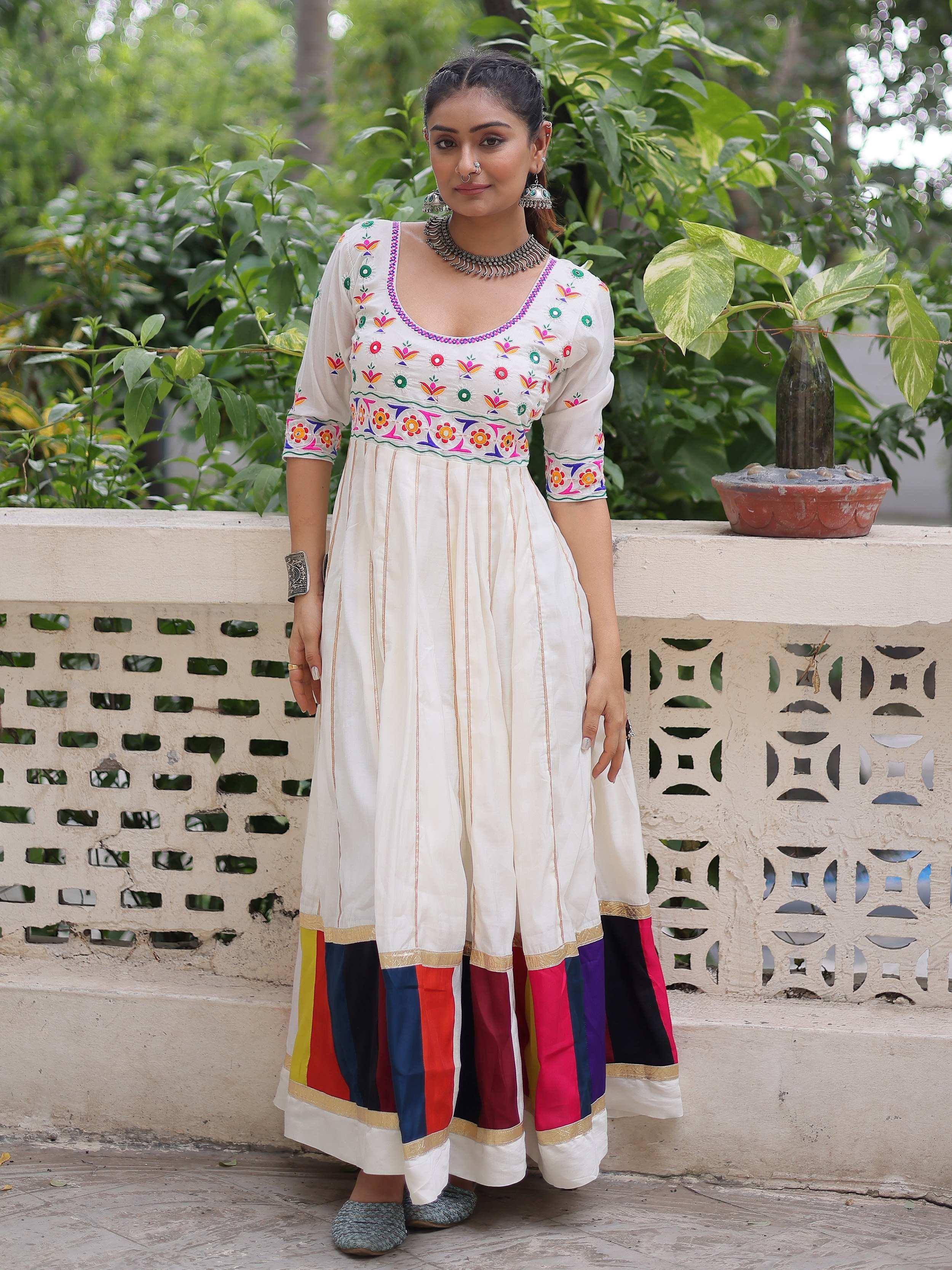 White embroidered Anarkali with colorful striped palazzo, perfect for Indian ethnic wear occasions